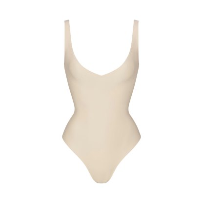 SKIMS BODY UNLINED PLUNGE THONG BODYSUIT - SAND