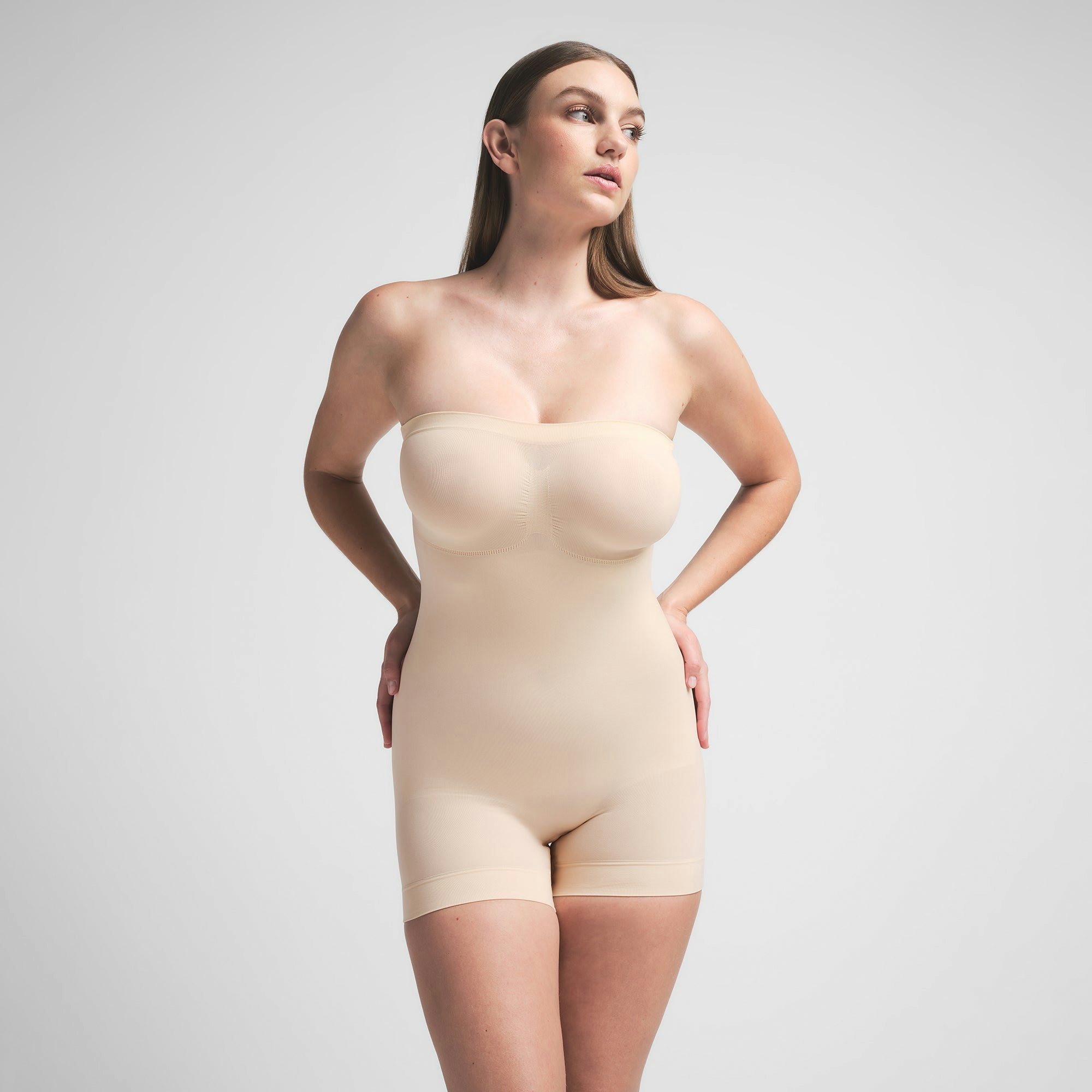SEAMLESS SCULPT STRAPLESS SHORTIE BODYSUIT - SAND