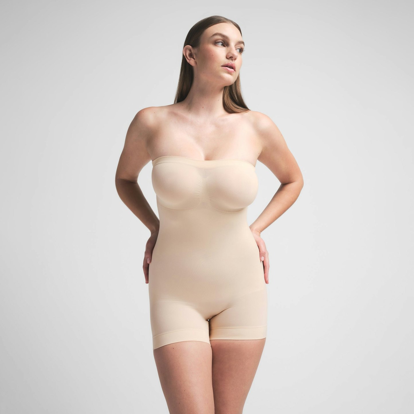 SEAMLESS SCULPT STRAPLESS SHORTIE BODYSUIT - SAND