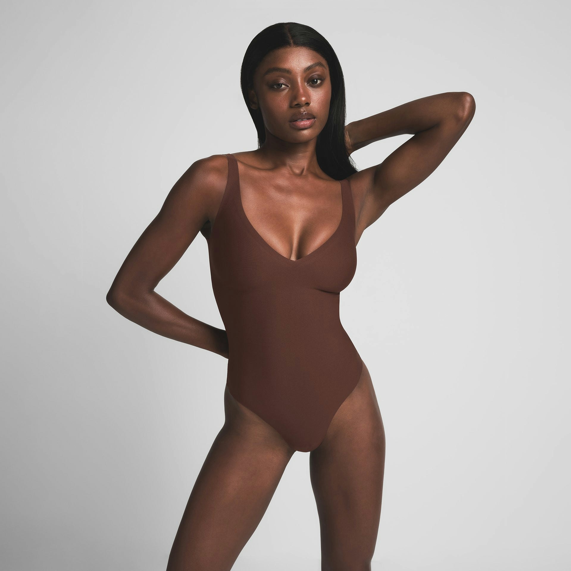 SKIMS BODY UNLINED PLUNGE THONG BODYSUIT - COCOA