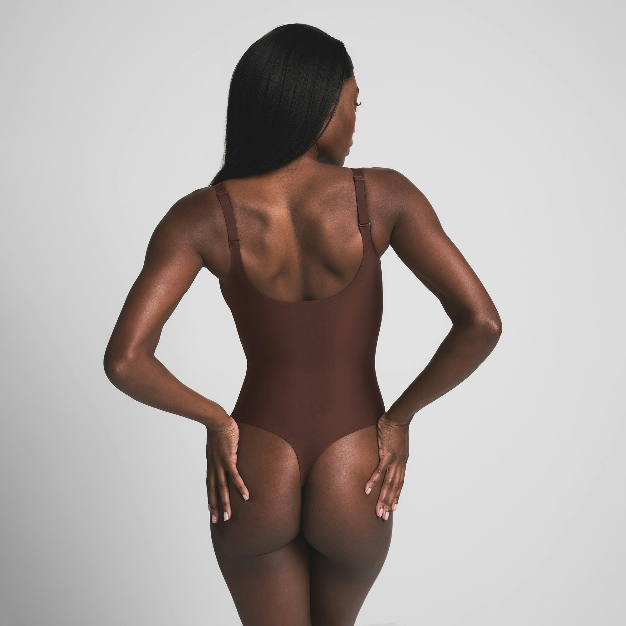 SKIMS BODY UNLINED PLUNGE THONG BODYSUIT - COCOA