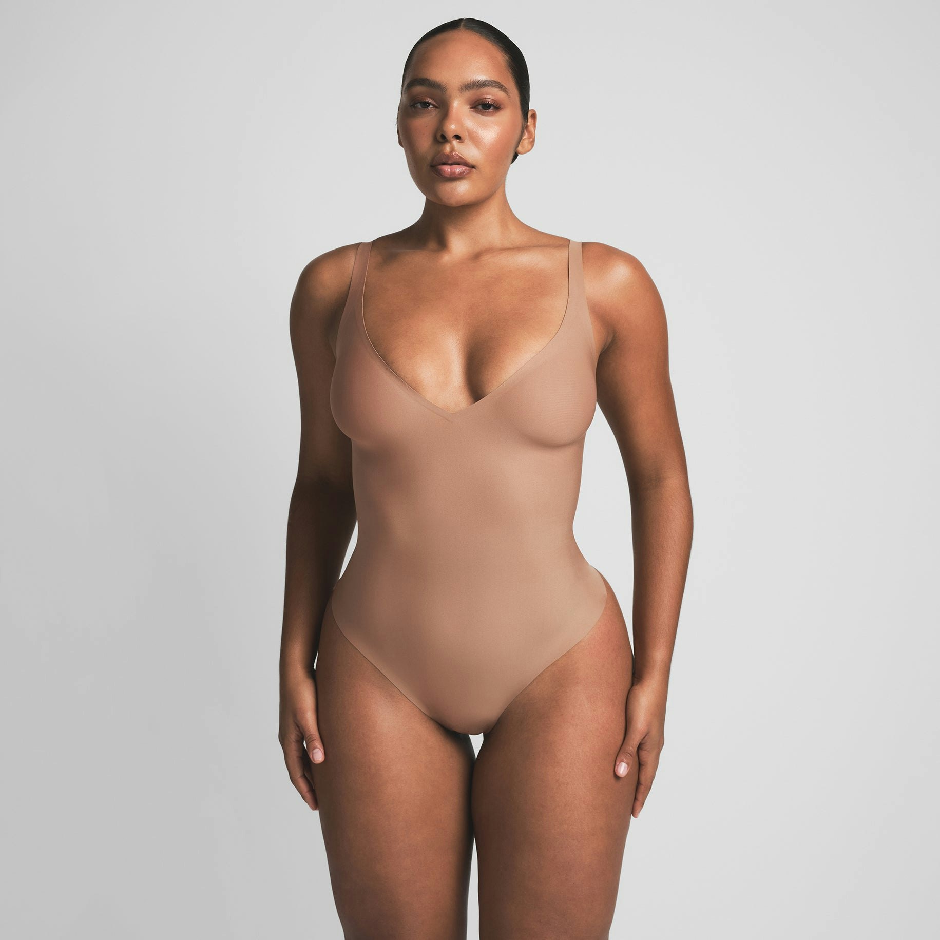 SKIMS BODY UNLINED PLUNGE THONG BODYSUIT - SIENNA