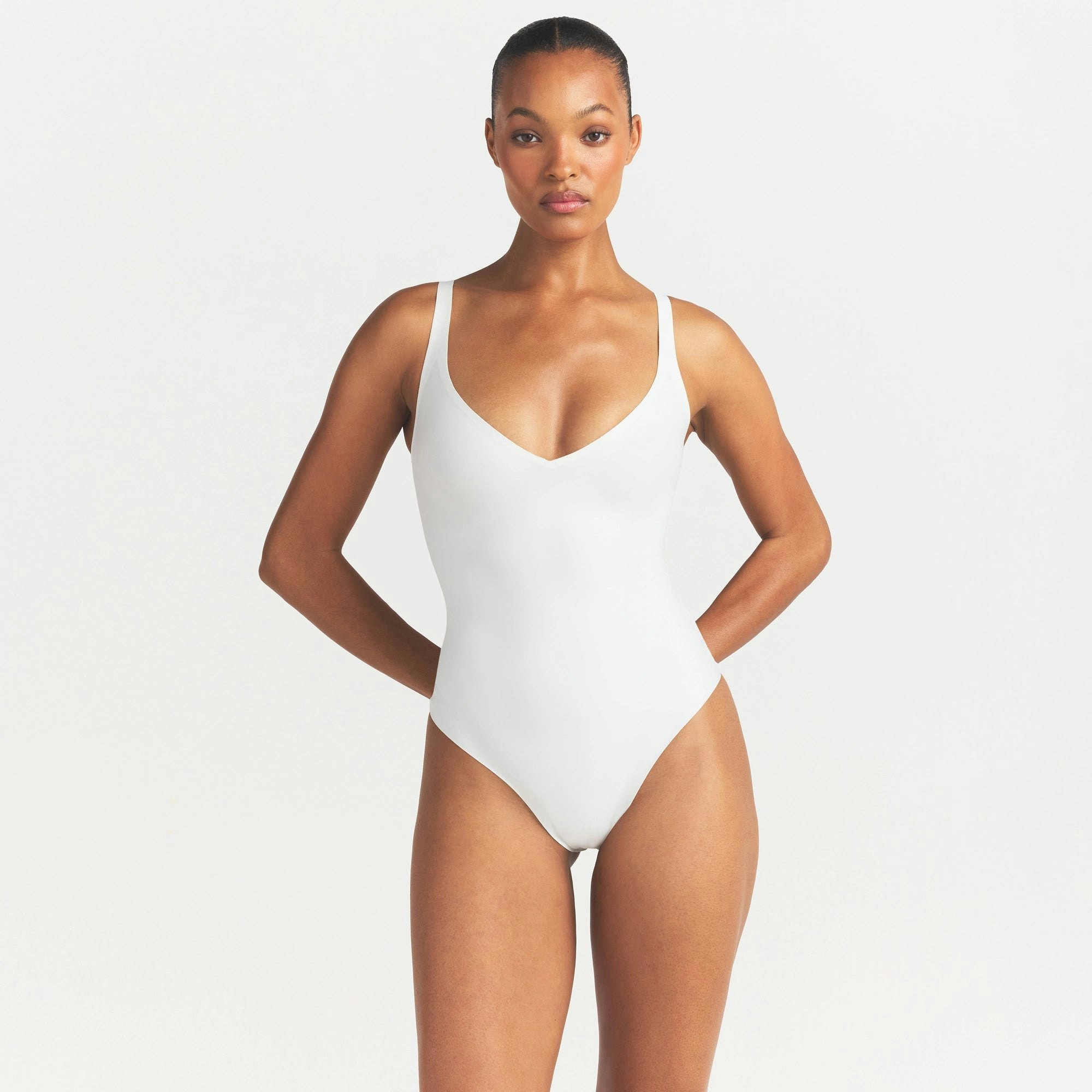 SKIMS BODY UNLINED PLUNGE THONG BODYSUIT - IVORY