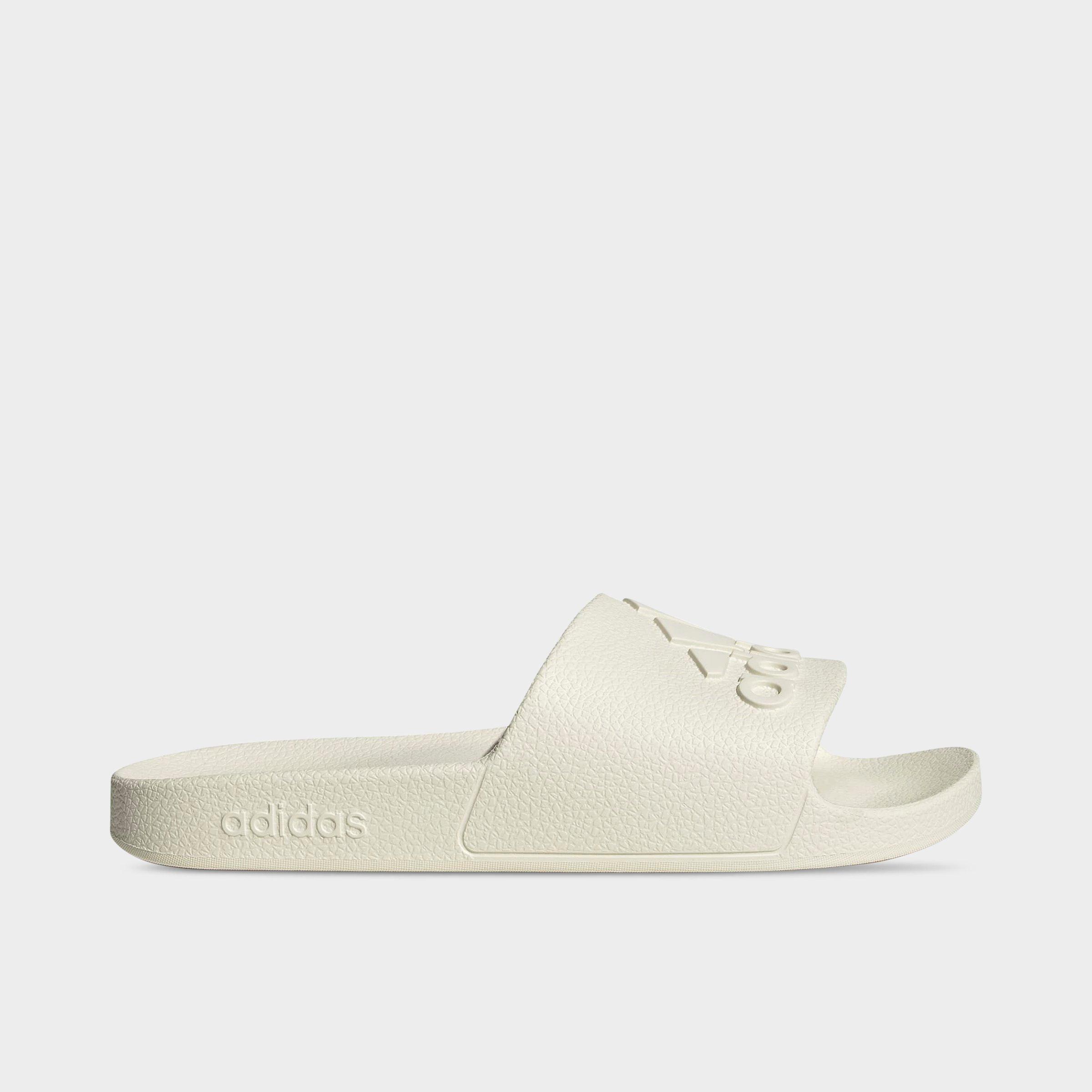 adidas adilette Aqua Slide Sandals - Off White/Off White/Off White - Left shoe facing left. Outside of the shoe.