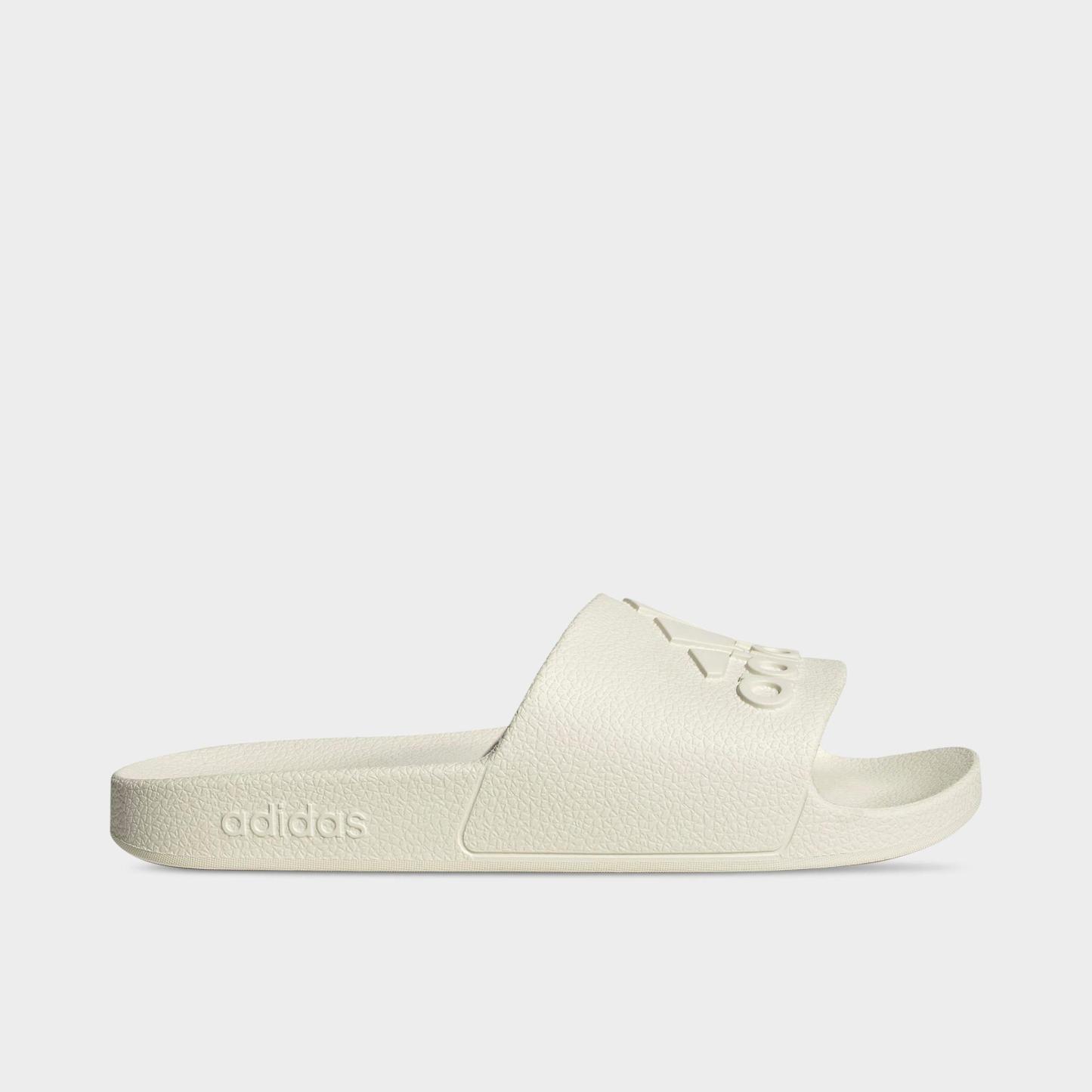 adidas adilette Aqua Slide Sandals - Off White/Off White/Off White - Left shoe facing left. Outside of the shoe.