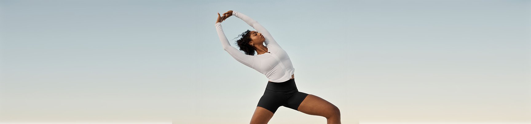 Alo yoga studio showing class attendees stretching