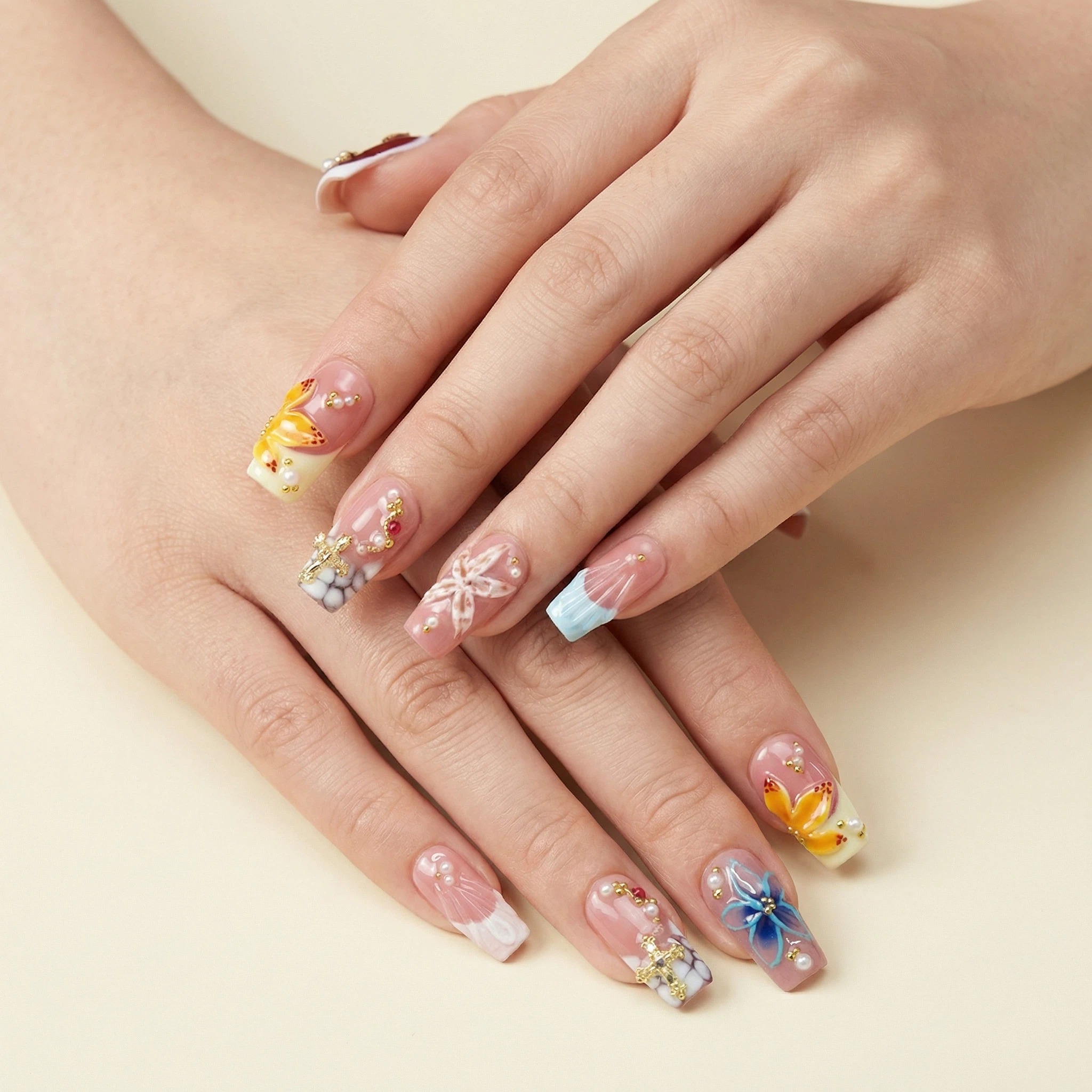 Model wearing nude pink floral press-on nails with butterfly accents, glossy finish close-up