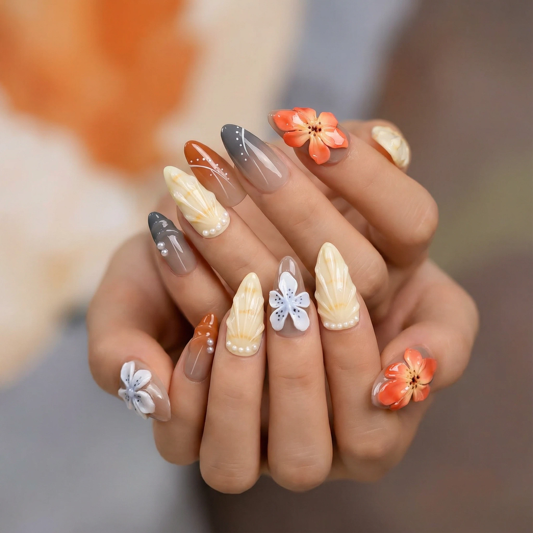 Fall press-on nails on hands — neutral cream and smoky gray nails with orange and blue 3D flowers for a soft autumn look