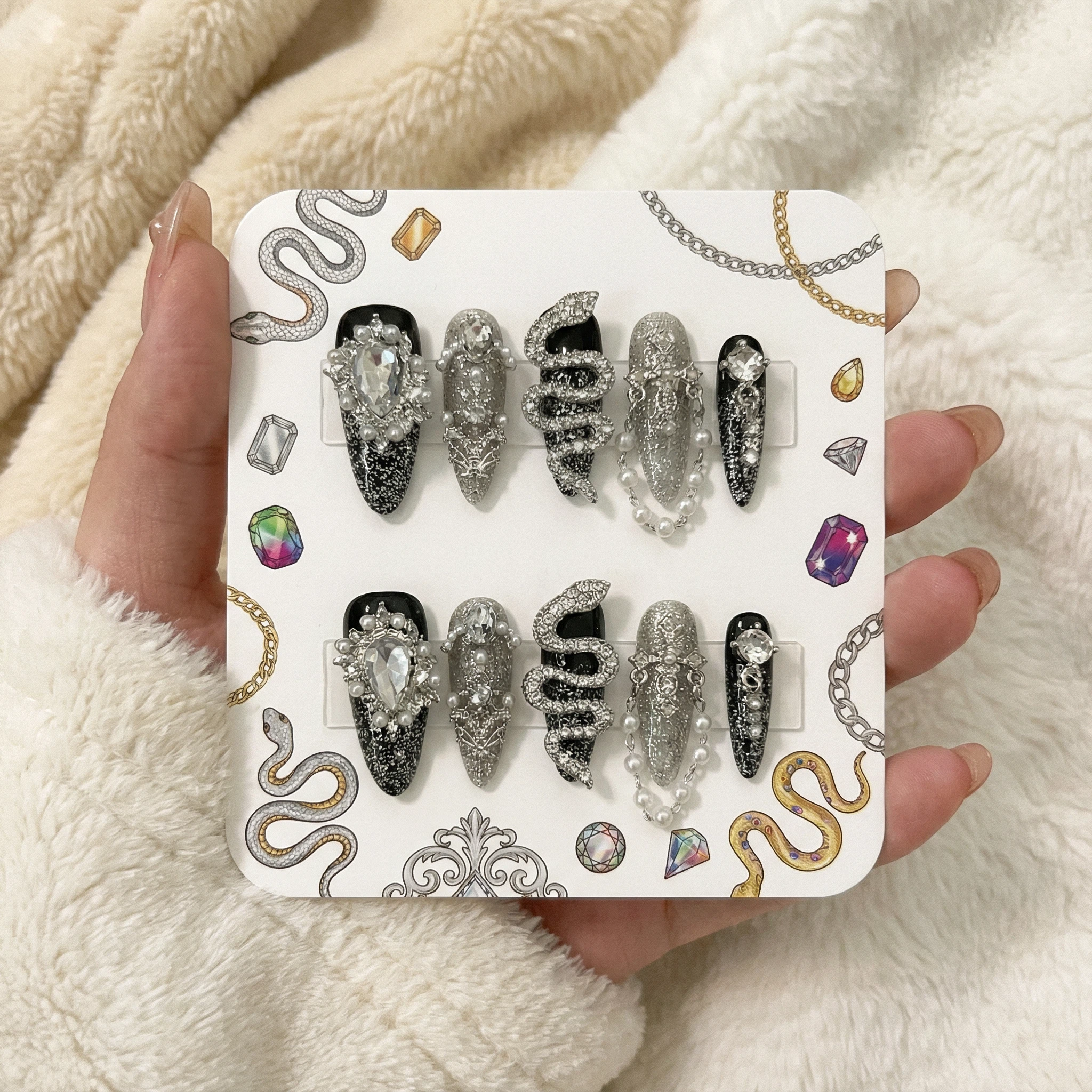 Black and silver luxury press-on nail set on display card with rhinestones and pearl-chain design