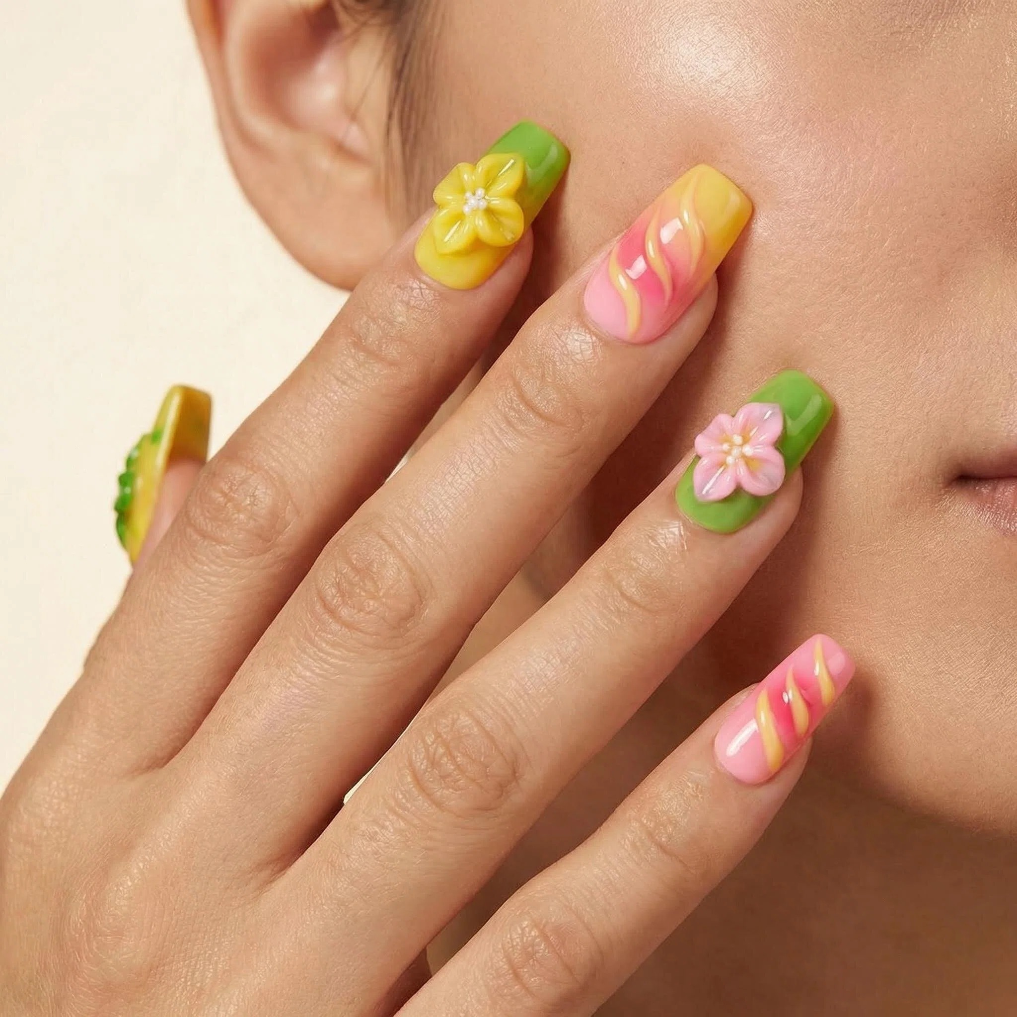 Close-up of colorful press-on nails with 3D daisy flowers, lime green and lemon yellow nail art