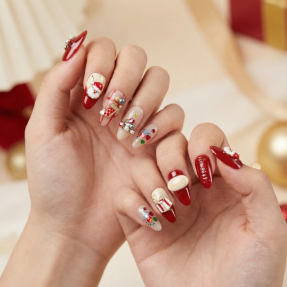 alt="Model wearing red and nude Christmas almond press on nails with Santa, stocking and crystal decorations"