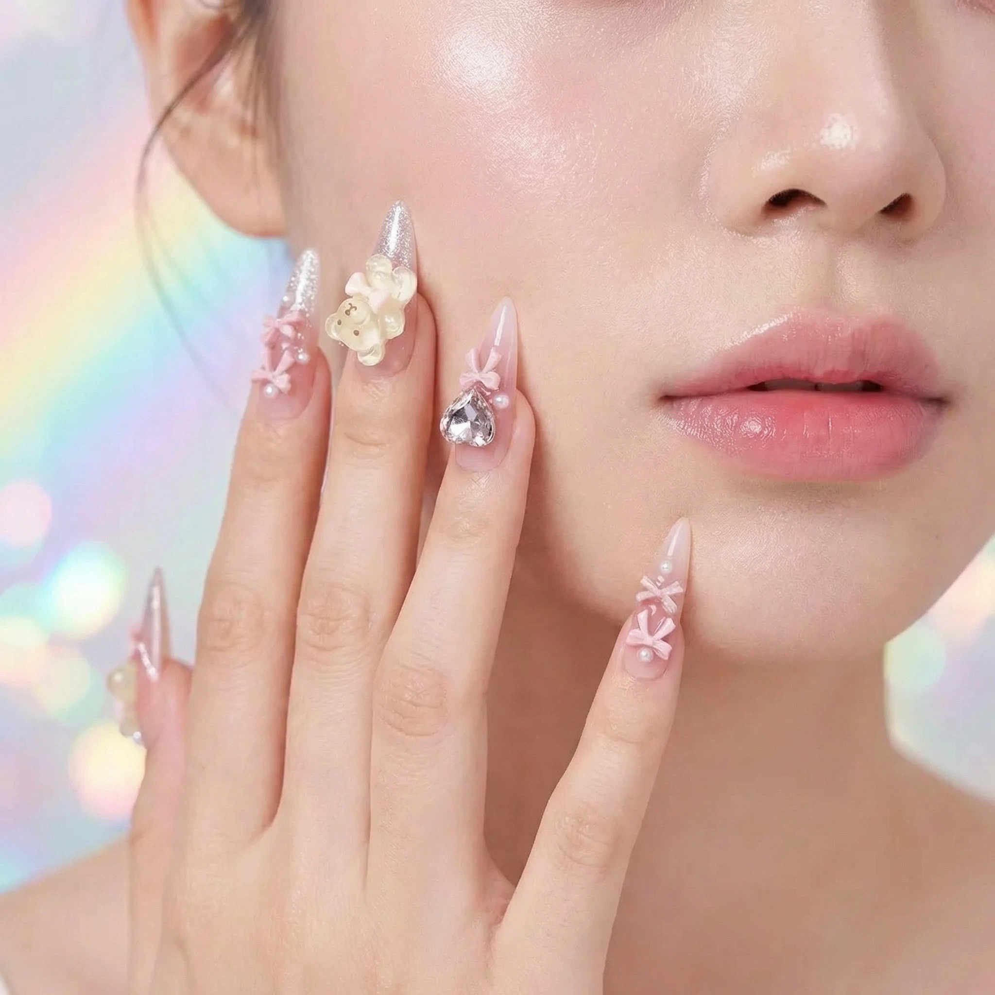 Model wearing romantic pink glam press on nails with 3D floral and rhinestone details