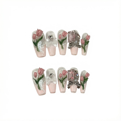alt="Pink tulip press on nails set with 3D flowers, bows and gems on long square tips"