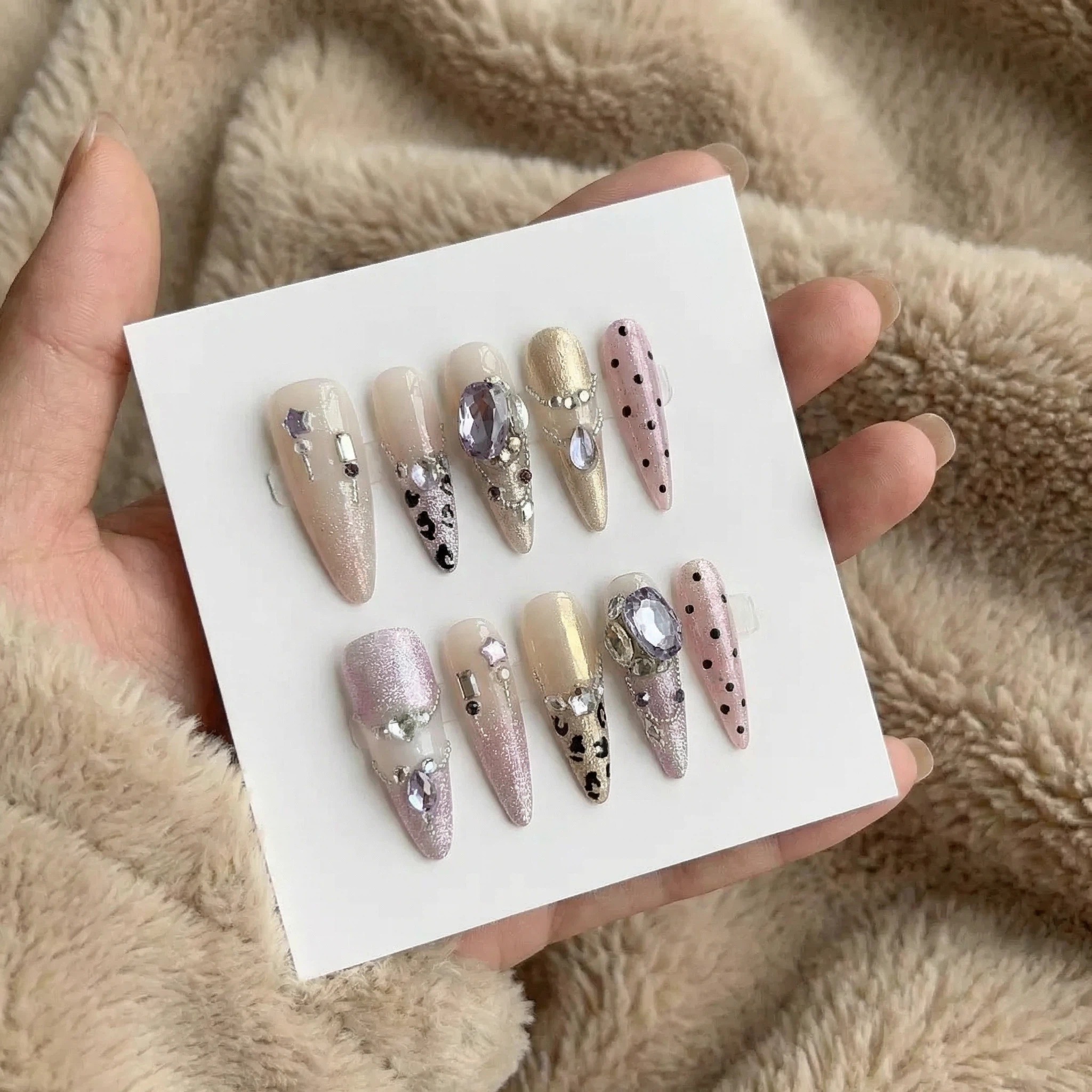 Silver ombré stiletto press-on nails set with crystal accents on display card