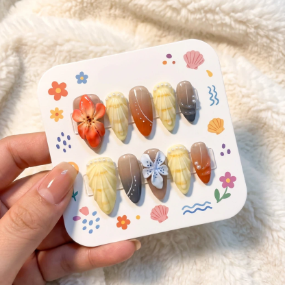 alt="Packaging card with orange and neutral 3D flower press on nails set in almond shape"