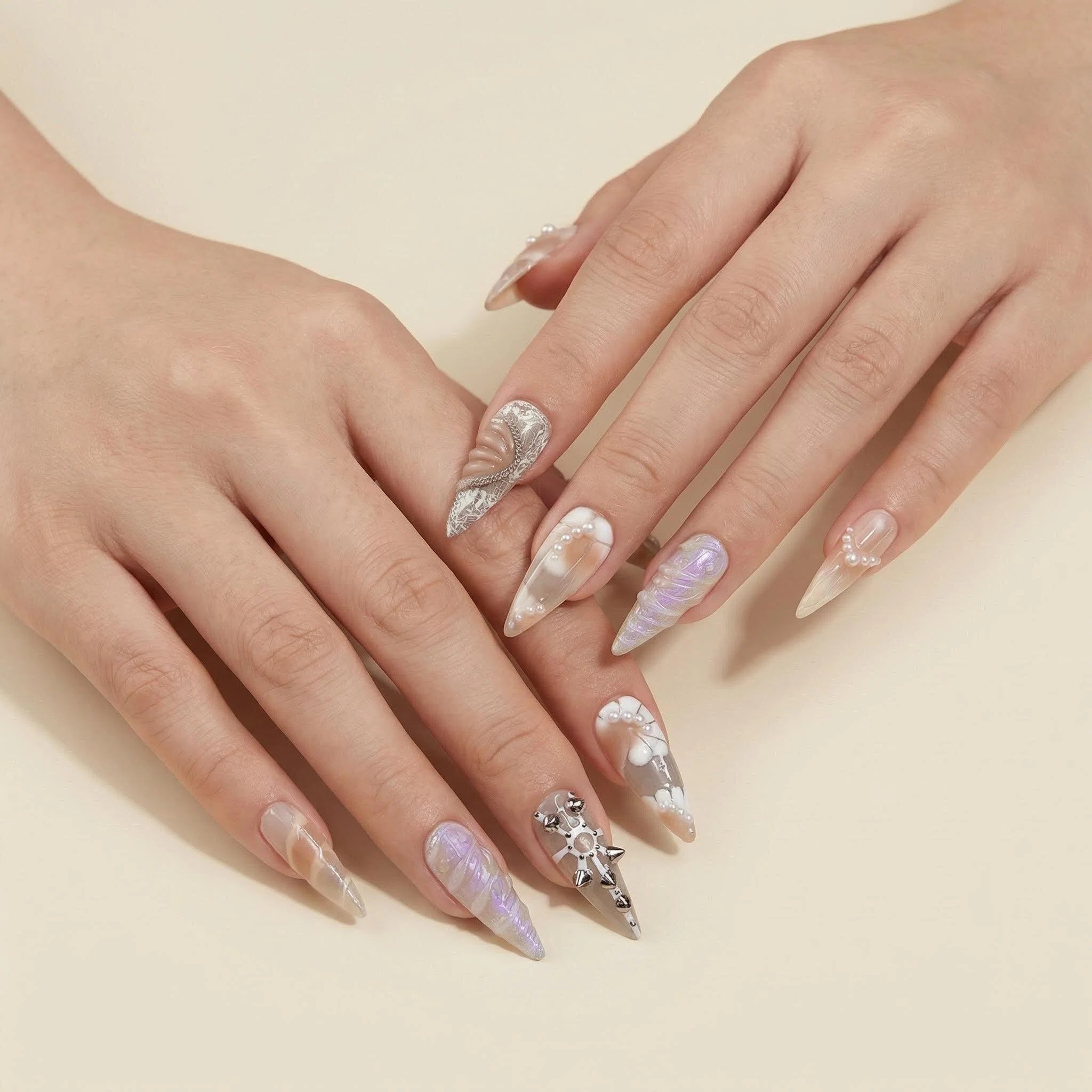 Nude champagne press-on nails with pearly chrome finish and subtle glitter on hands