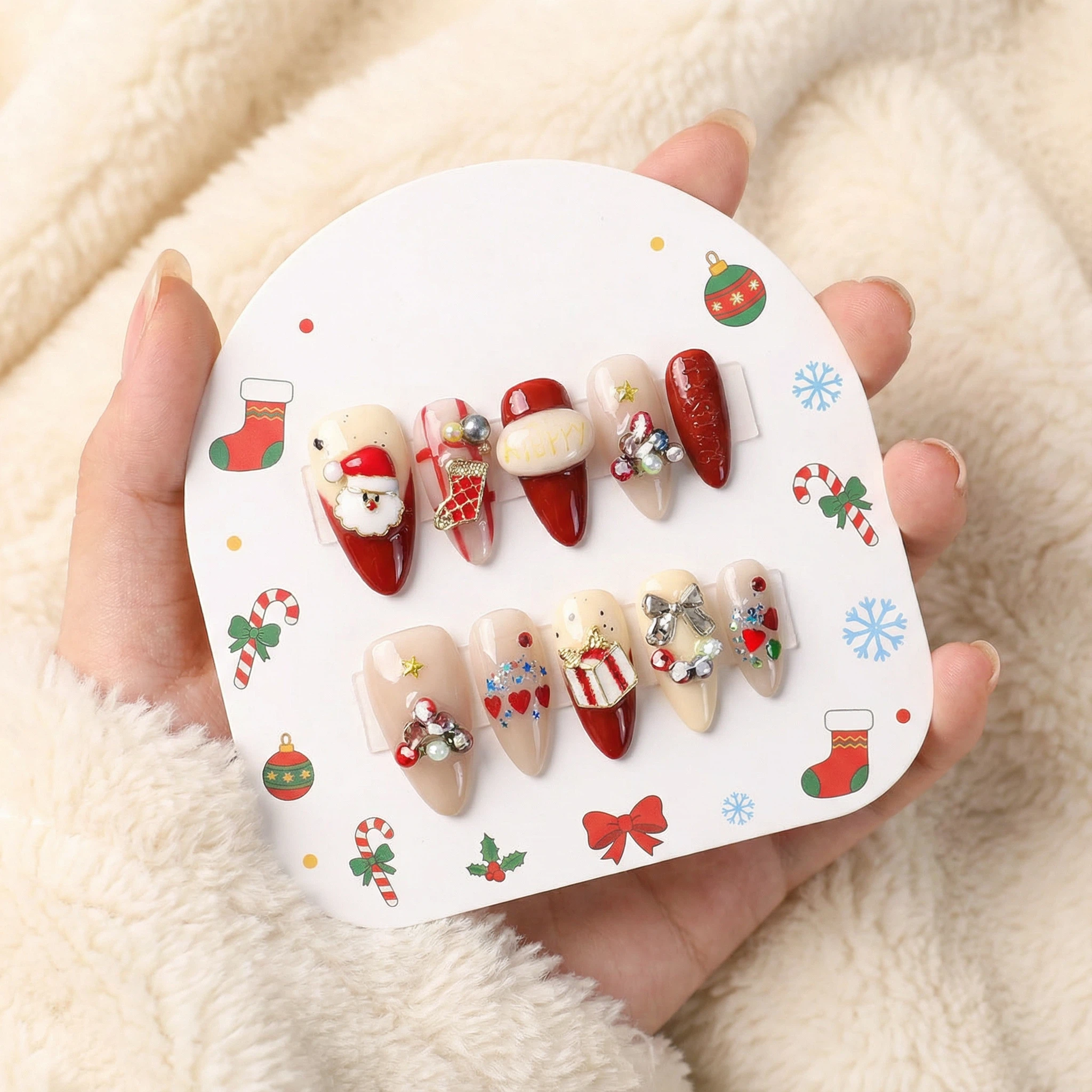 Christmas press-on nails set on display card, red and white holiday design with Santa and festive accents