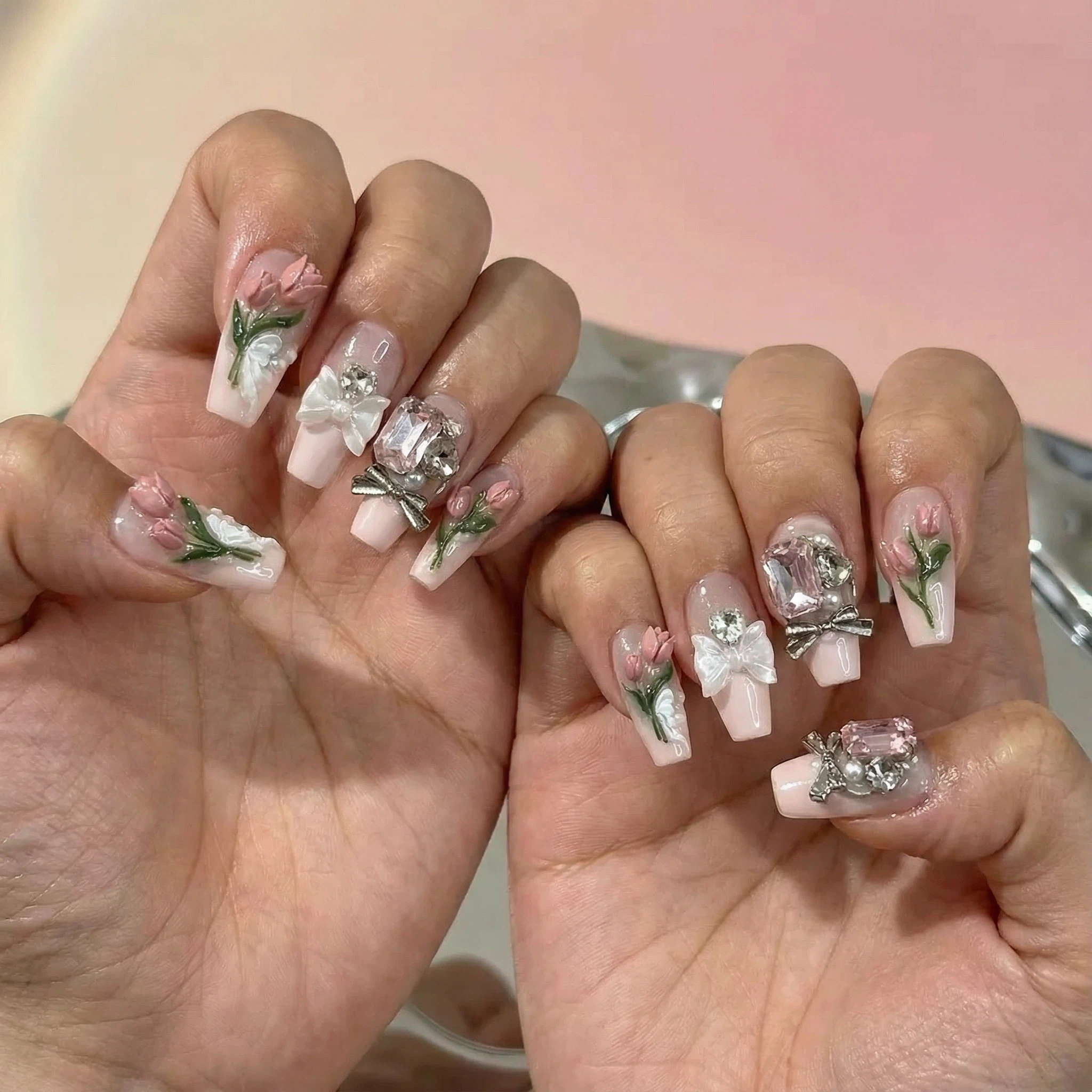 Green floral press-on nails on hands, salon-style 3D rose and shimmer details