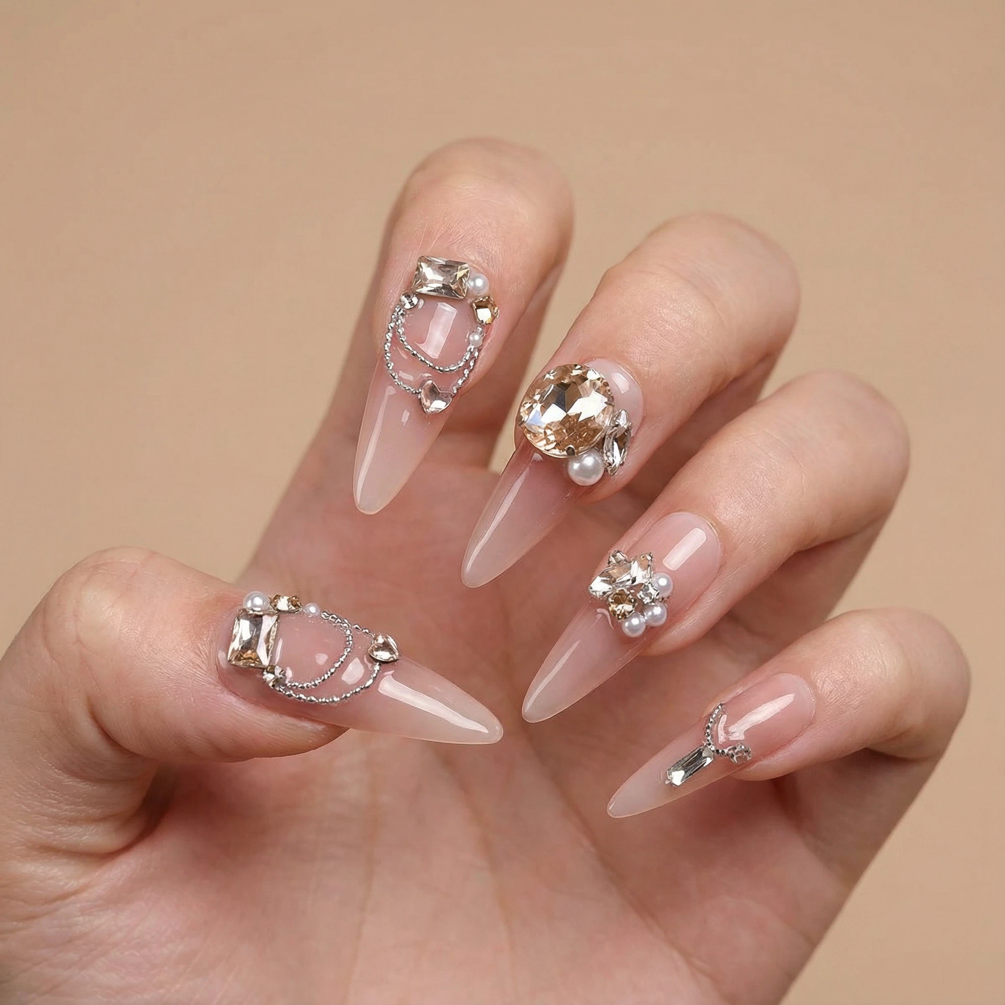Nude pink press-on nails with crystal rhinestones, elegant wedding manicure look