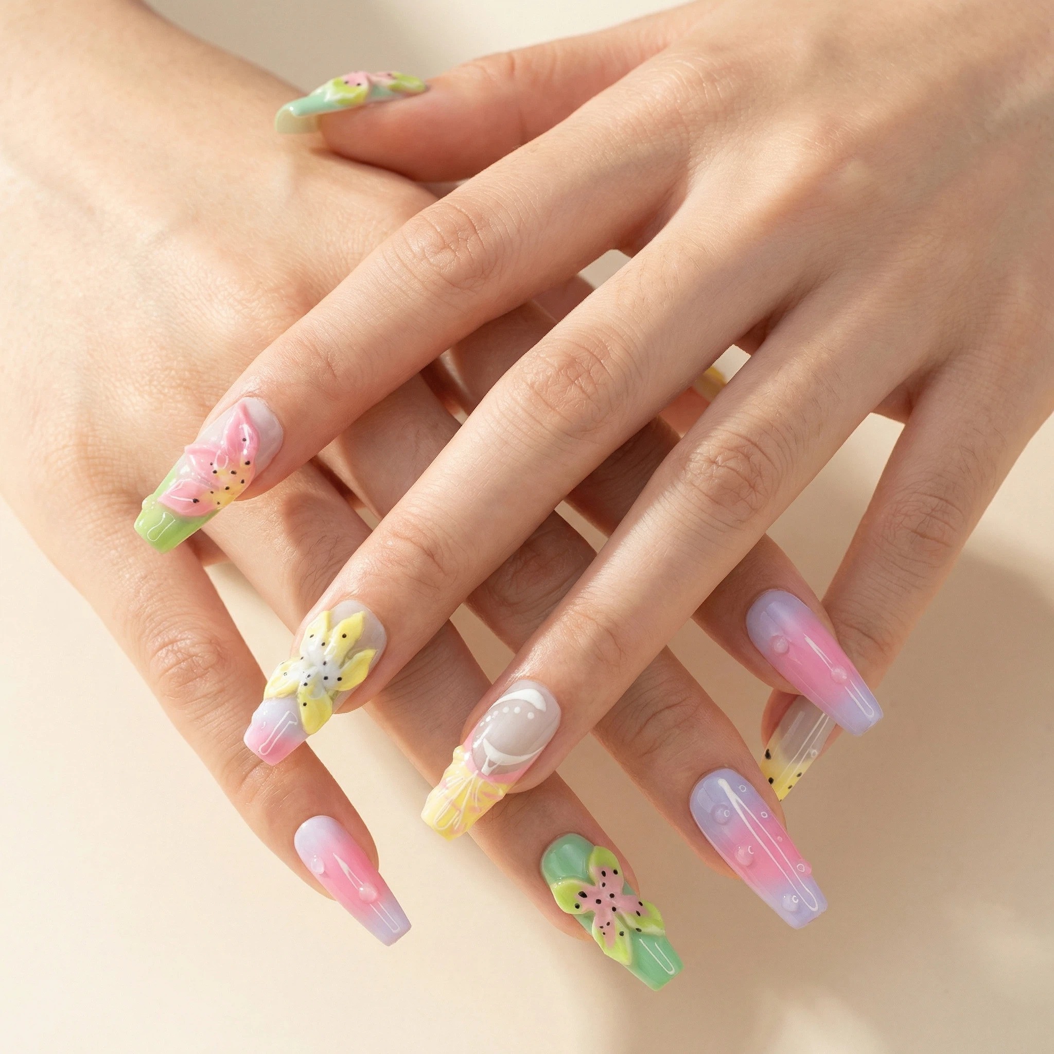 Model hands wearing spring pastel press-on nails with 3D flowers and glossy finish