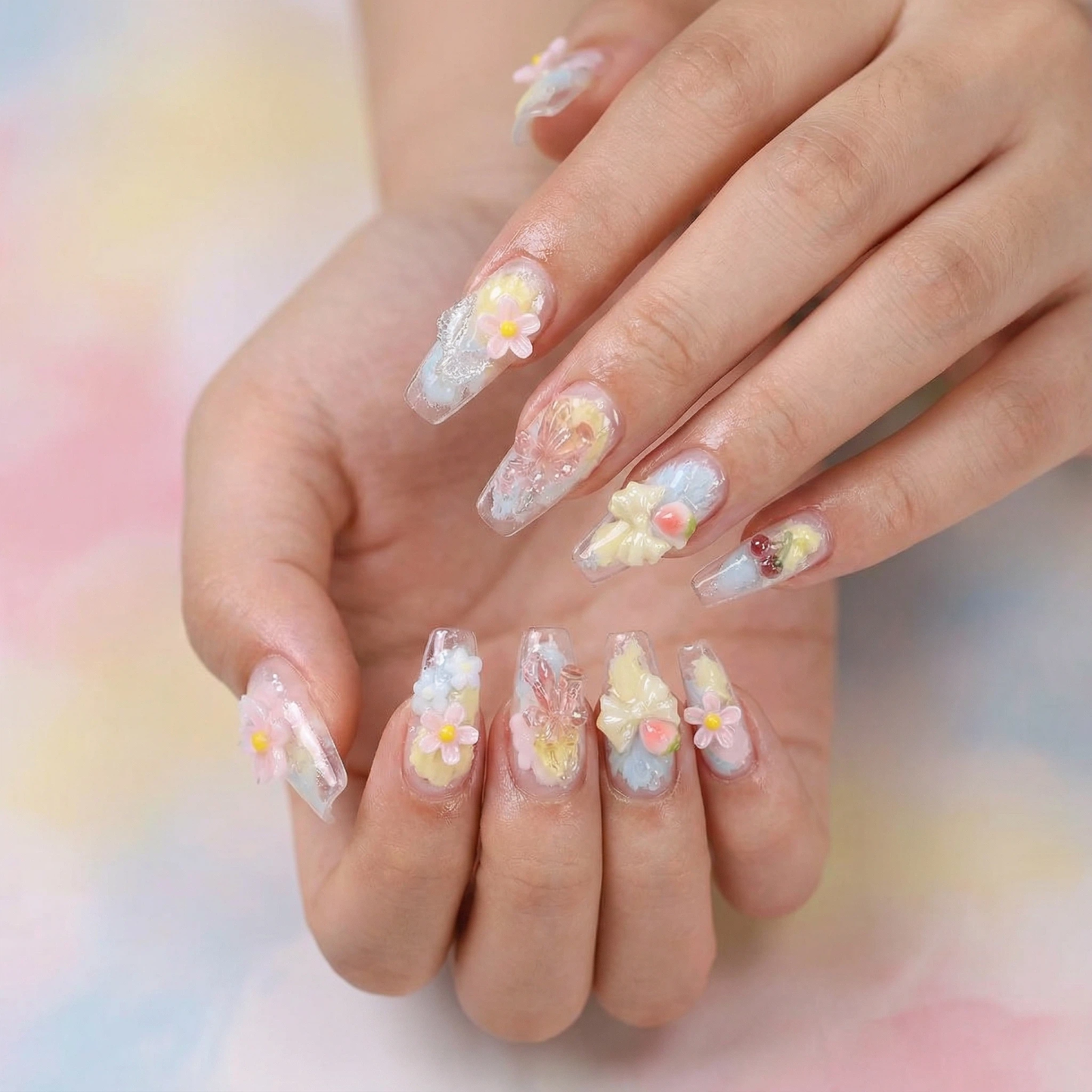 Pastel 3D floral press-on nails worn on hand, soft jelly gradient with delicate spring accents