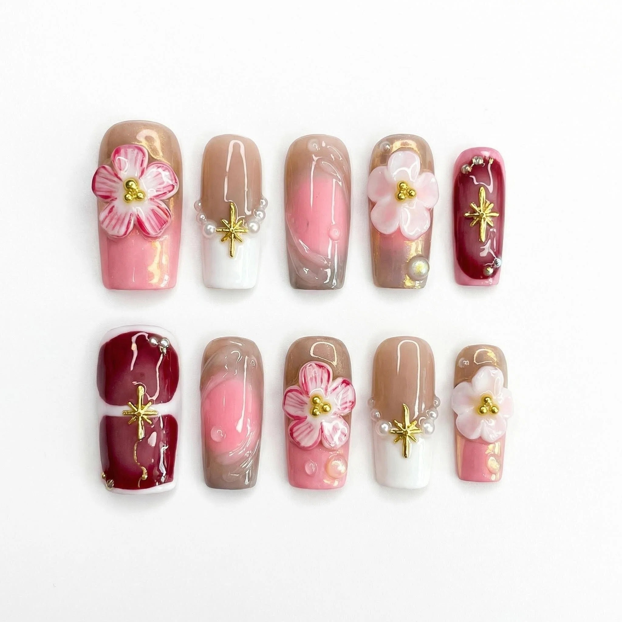 Full set of 10 blush nude and burgundy press-on nails with 3D flowers, pearls, and gold accents, reusable false nails