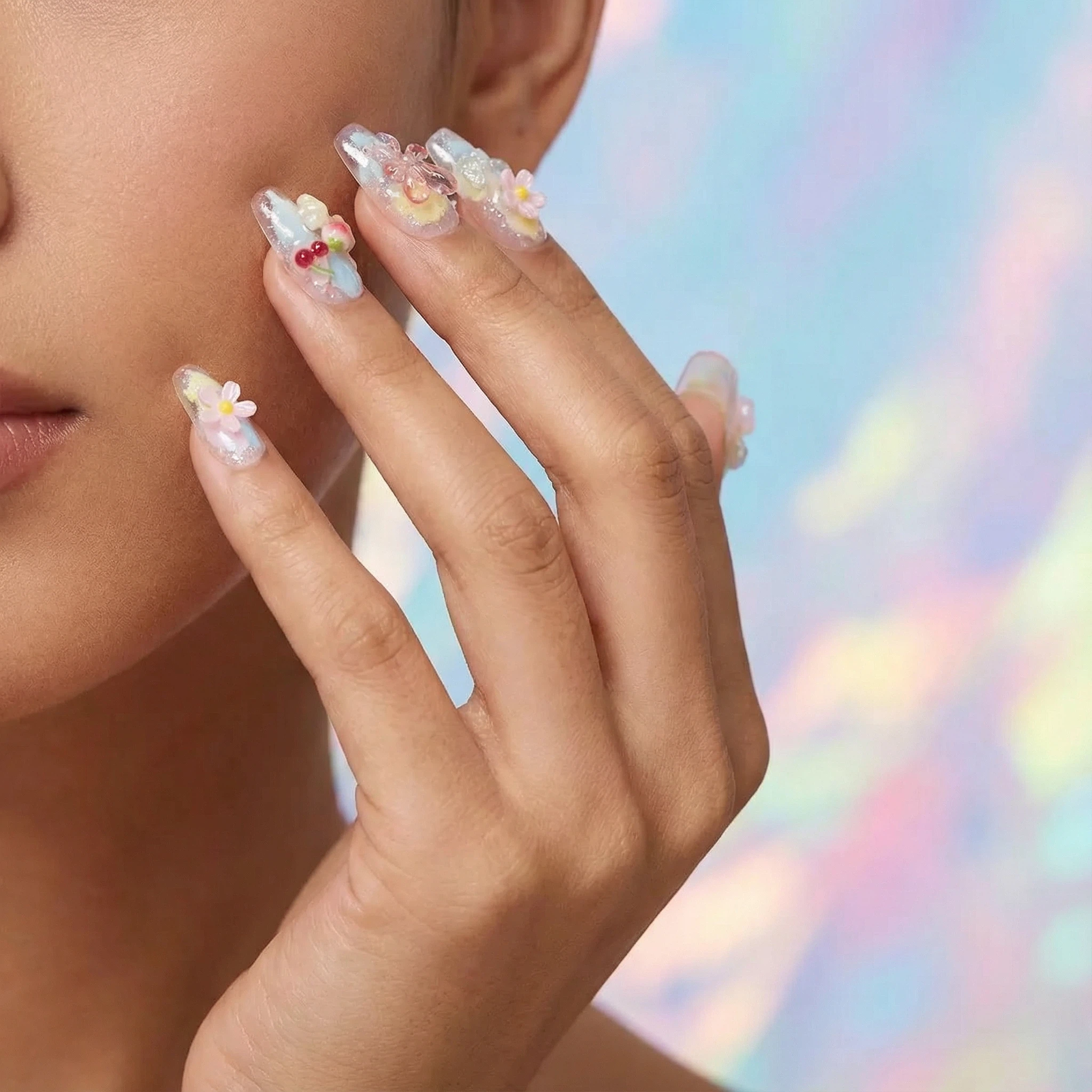 Model wearing pastel 3D flower press-on nails, glossy spring-summer style close-up