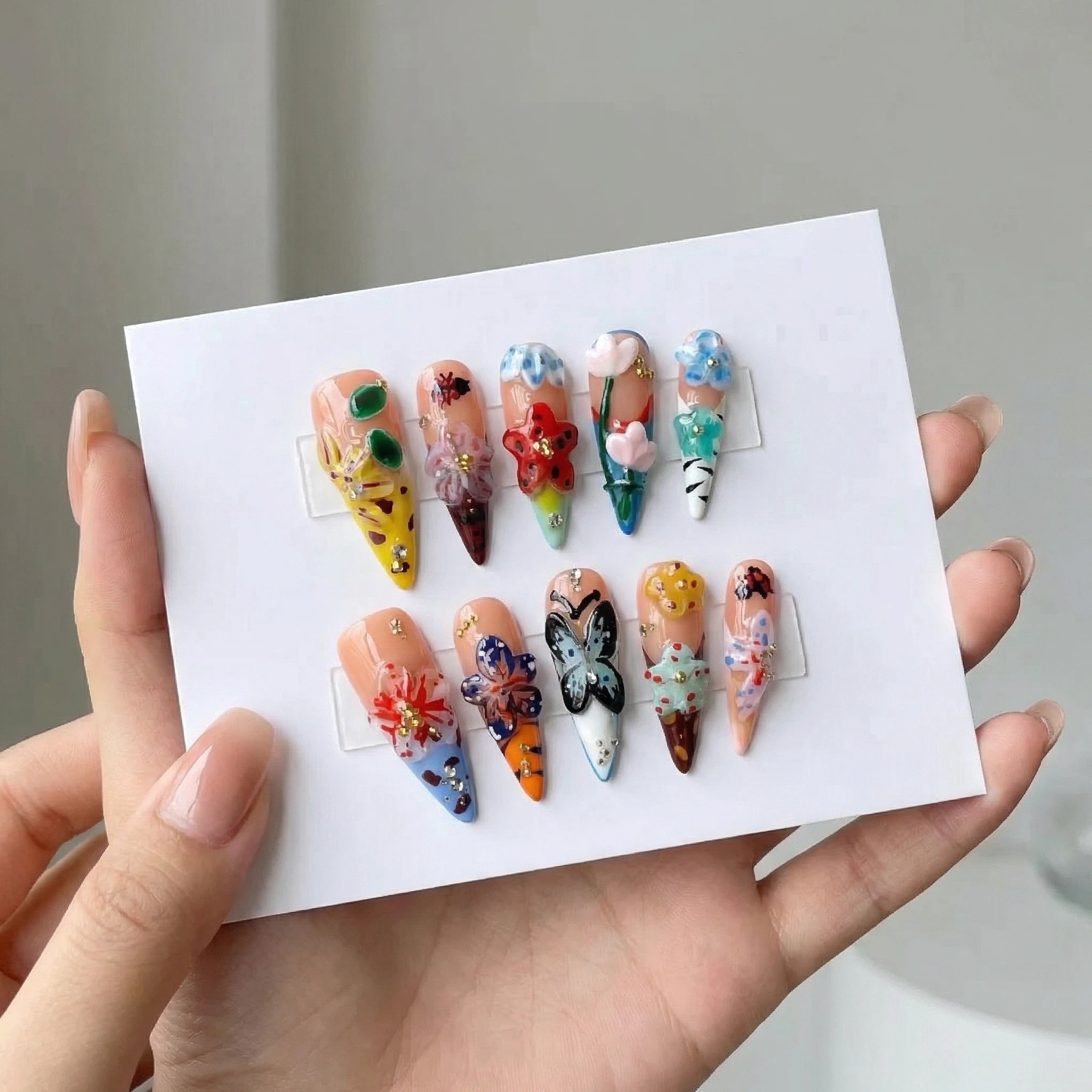 Cover： Colorful butterfly and floral press-on nails set with hand-painted mixed patterns, stiletto shape