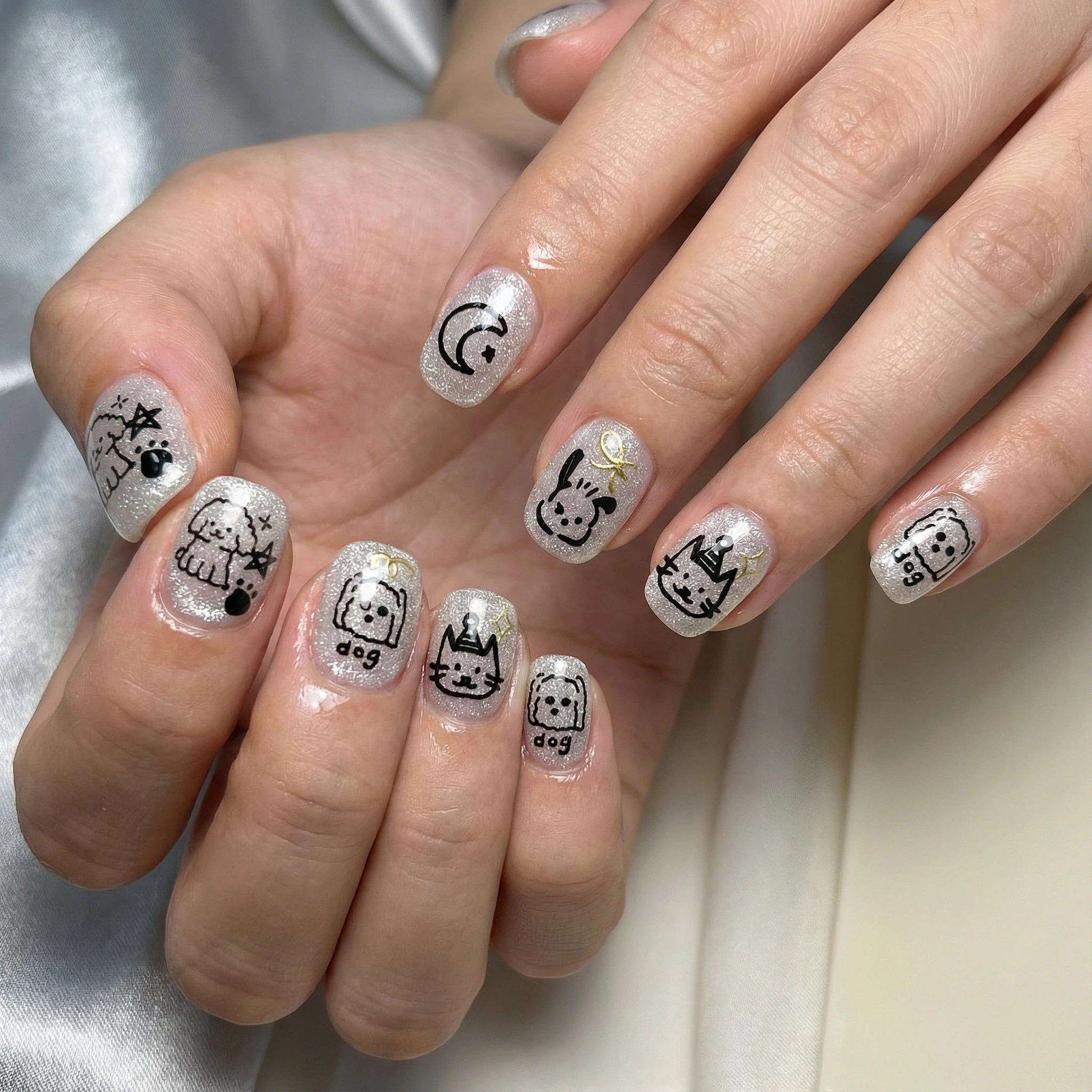 Short press-on nails with cute cat faces, black and white minimalist manicure look