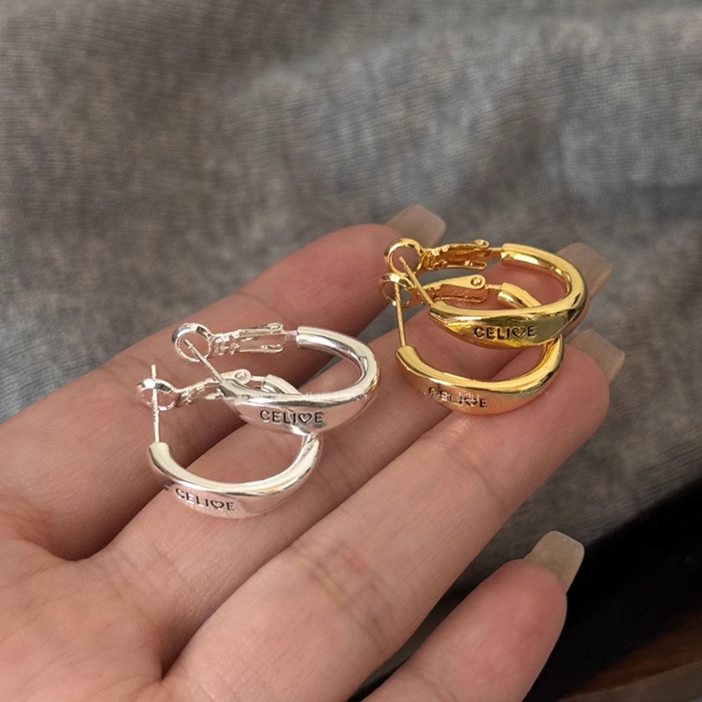Gold and silver tone hoop earrings showing hinged clasp and fastening details