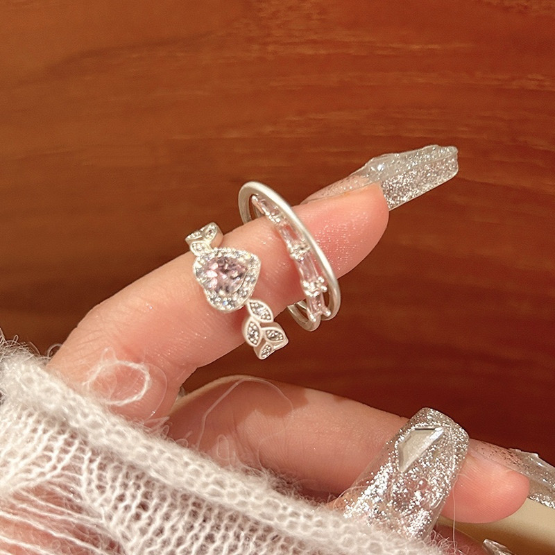 Close-up of silver pink heart rhinestone ring with delicate leaf details