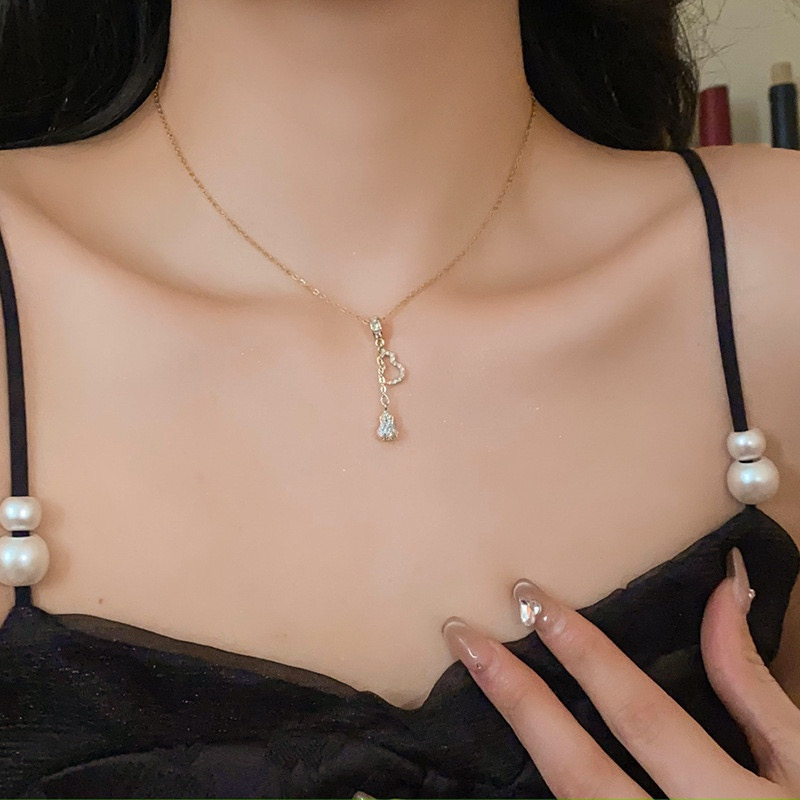 Elegant gold zircon gourd pendant necklace styled with a black dress for everyday wear
