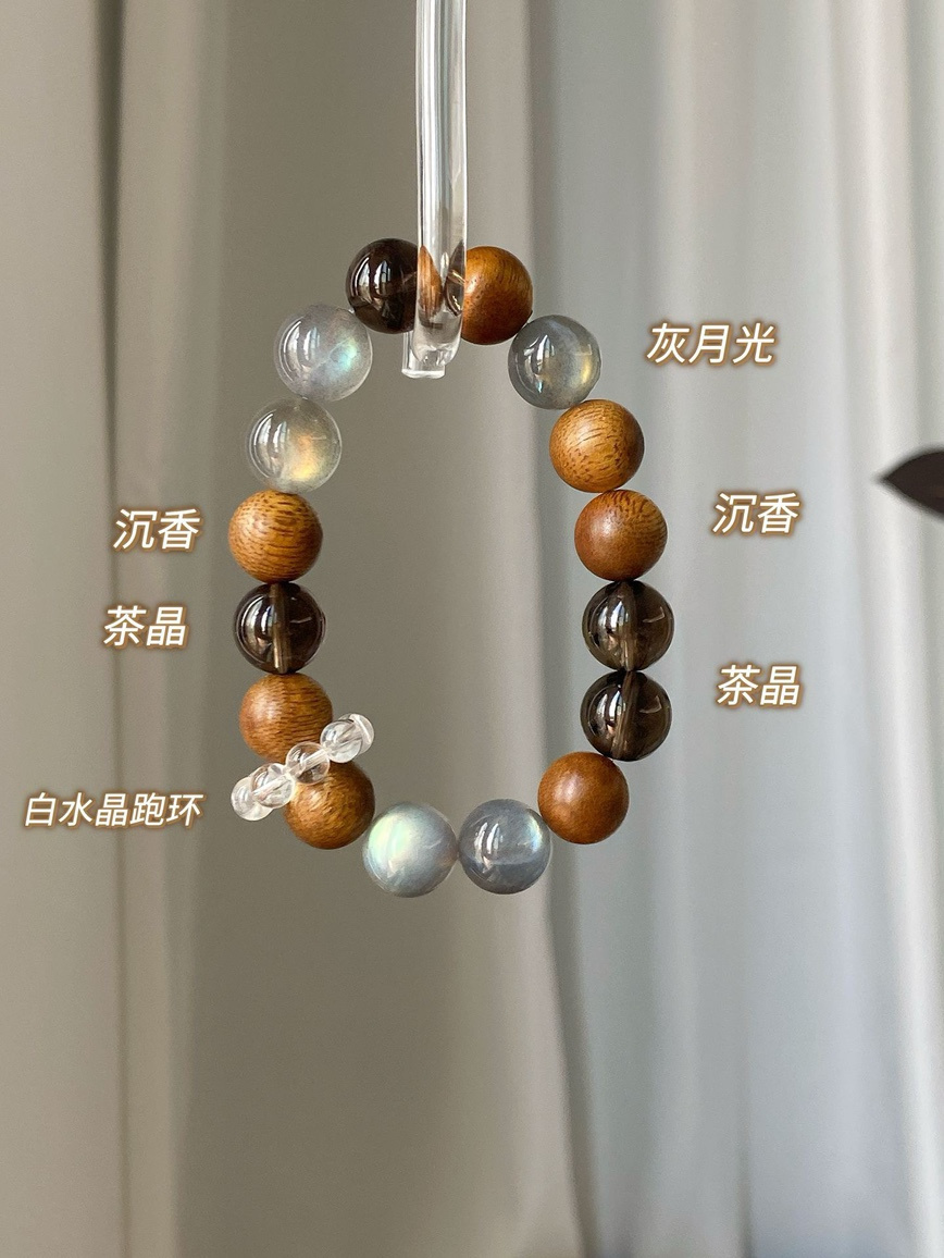 Macro shot – smoky quartz and moonstone shimmer highlighting craftsmanship.