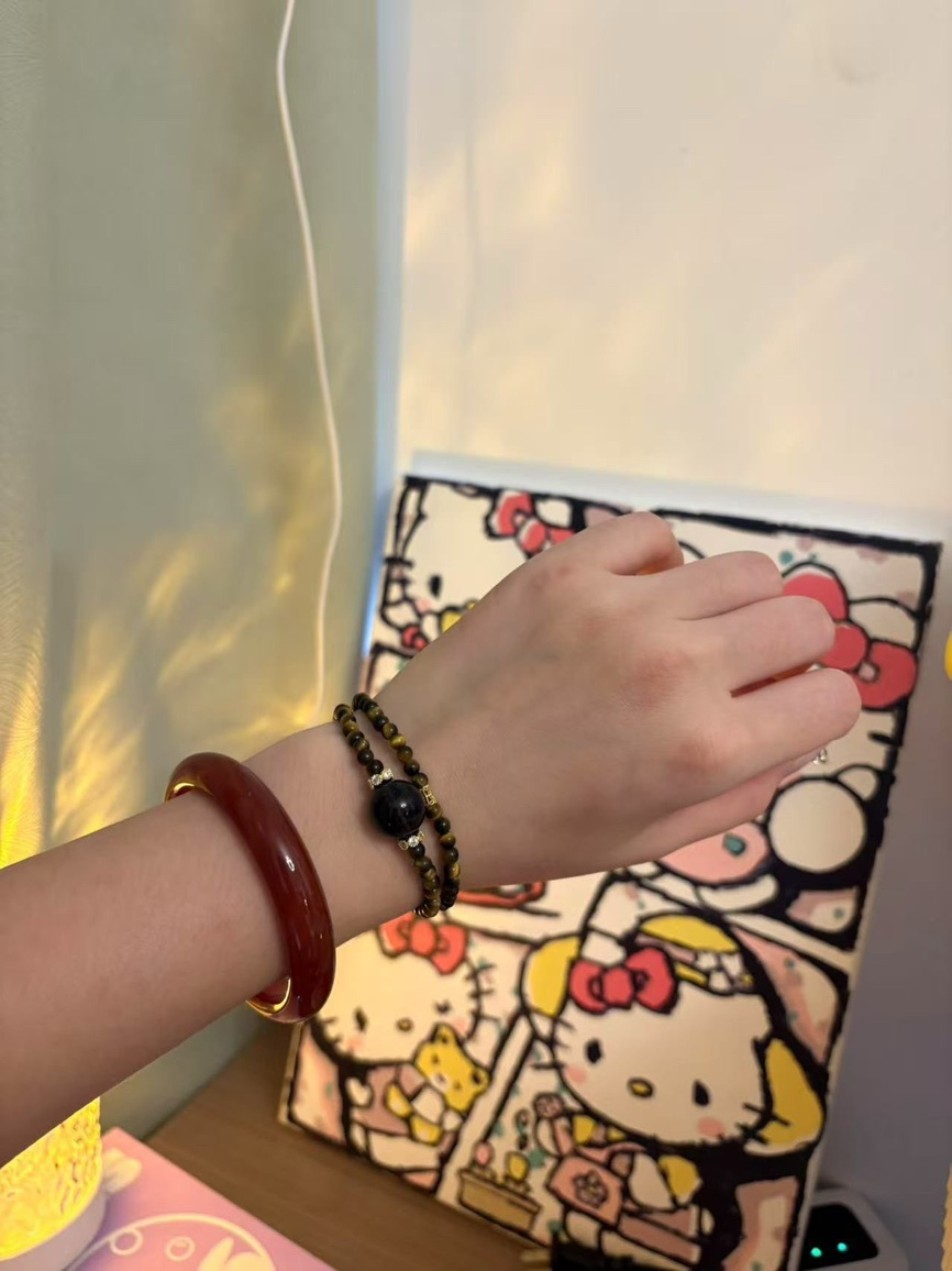Wrist wearing double Tiger’s Eye and Obsidian bracelet with jade bangle