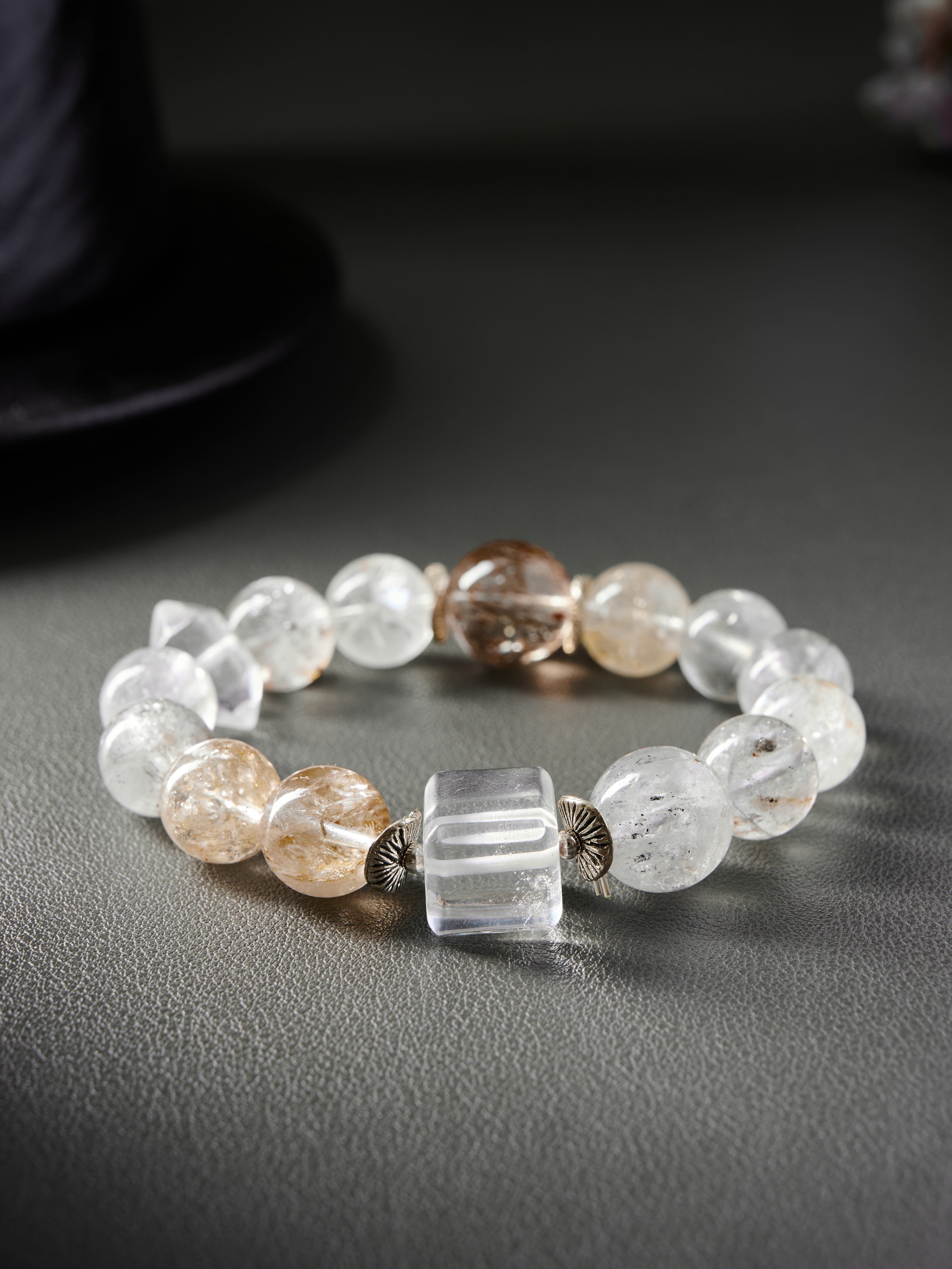 Close-up – rutile threads inside clear quartz beads, polished round surface and natural texture.