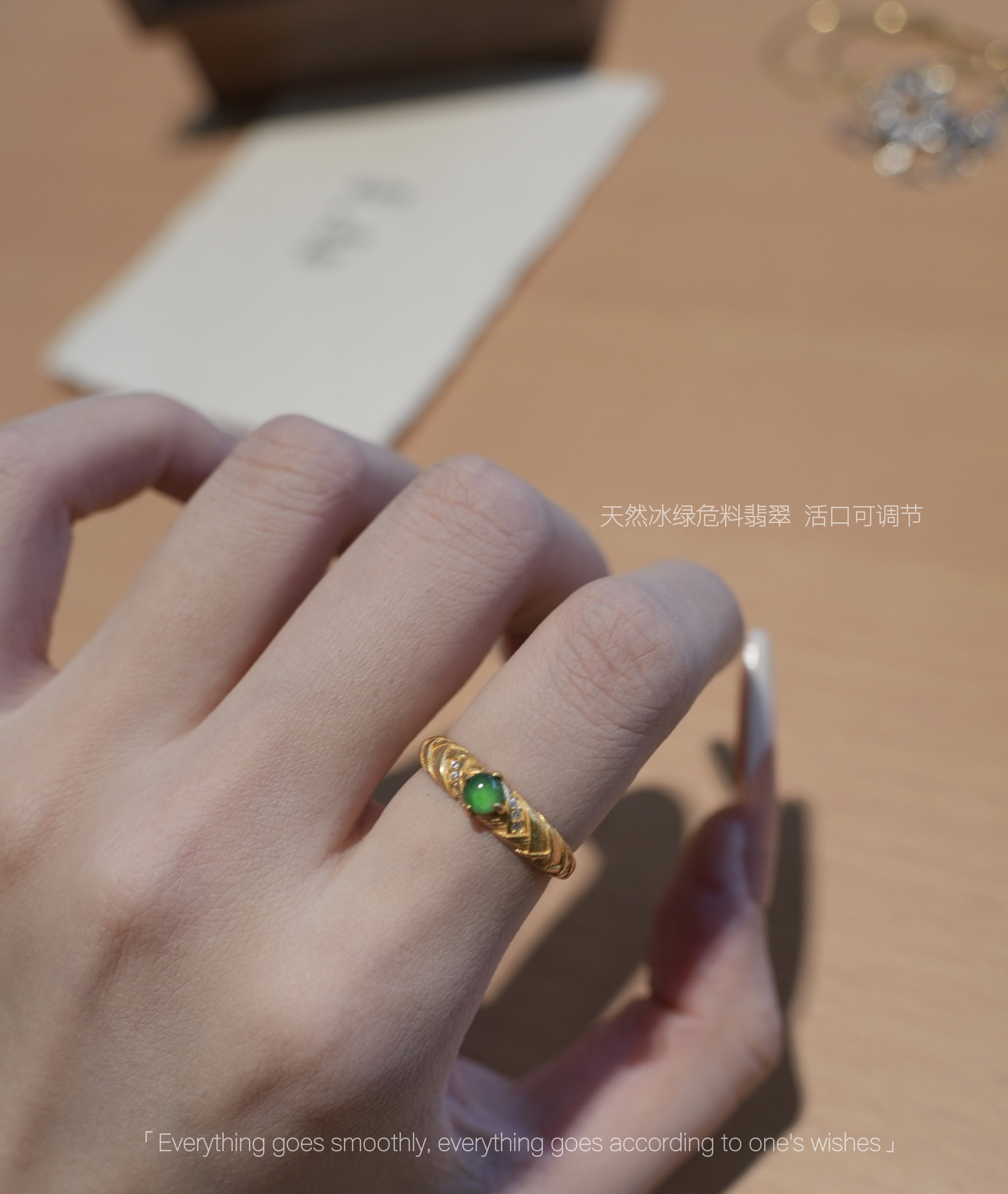 Natural jade green gemstone ring worn on hand under soft light