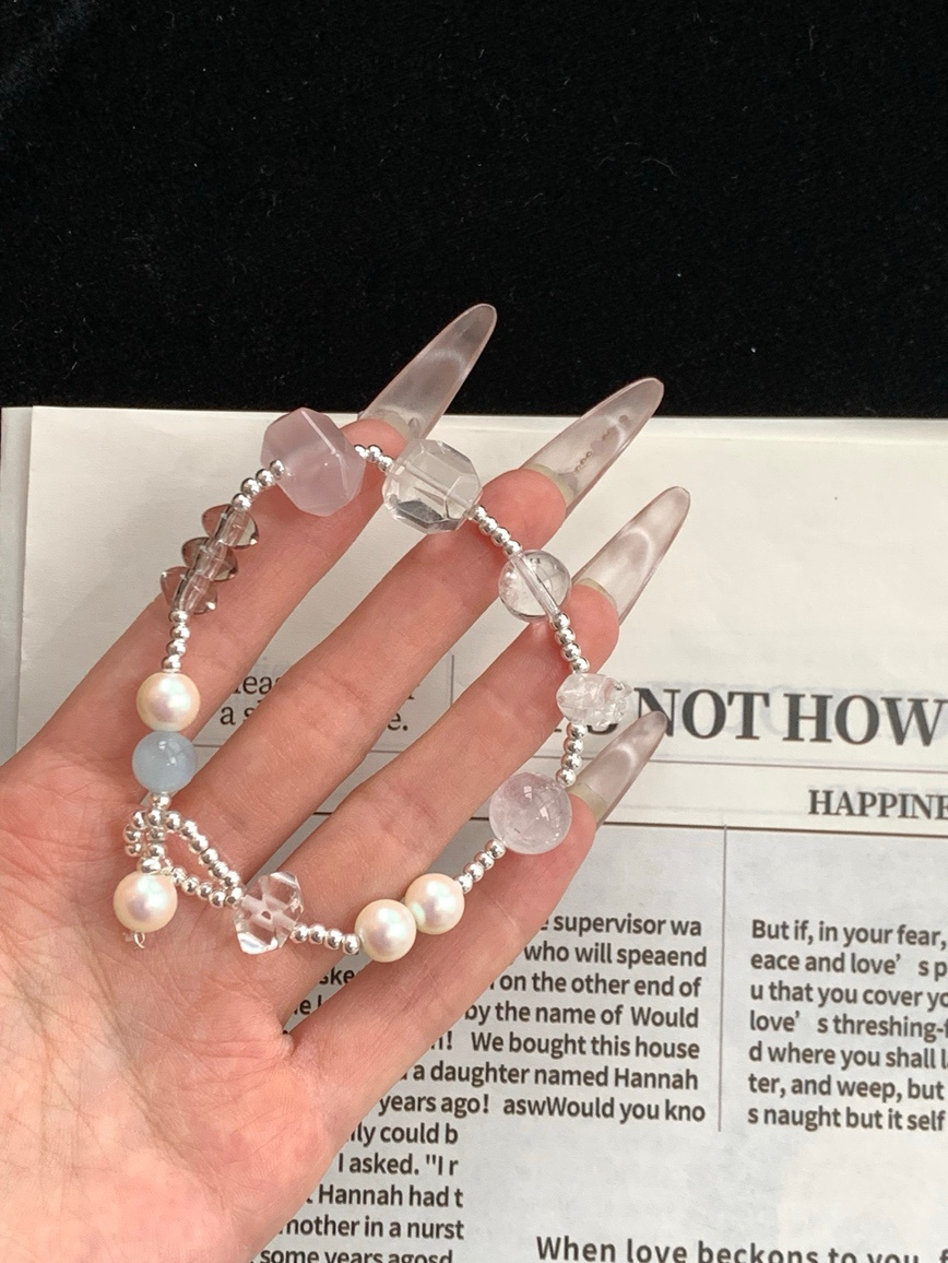 Close-up of handmade crystal beads featuring smoky and clear quartz.