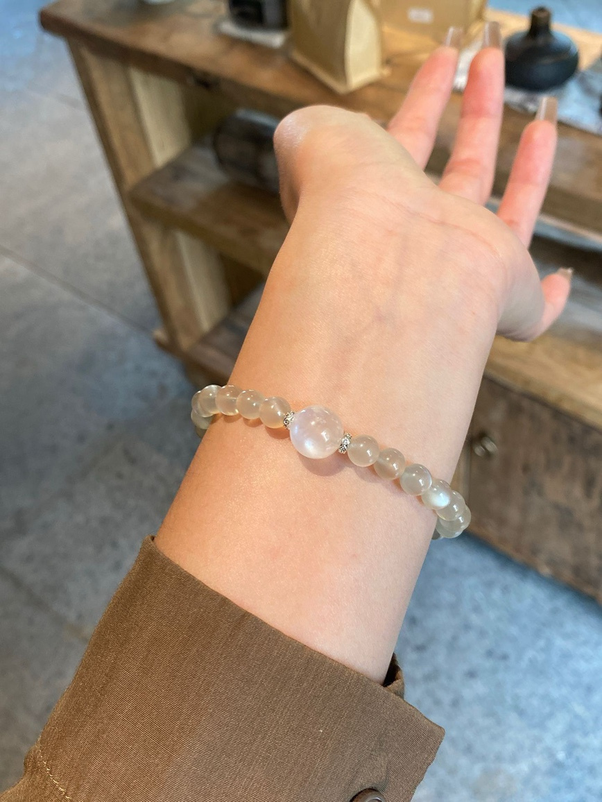Lifestyle shot – moonstone bracelet worn with neutral outfit for daily elegance.