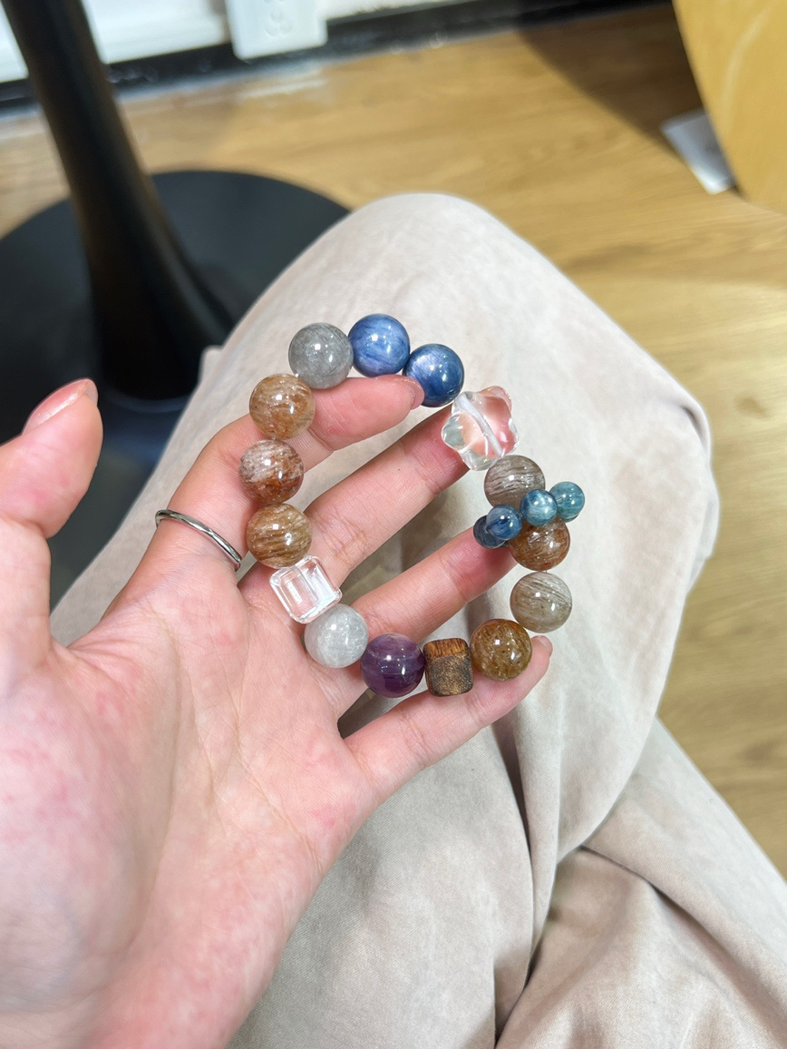 Blue Kyanite, Apatite, and Clear Quartz bracelet close-up view on hand