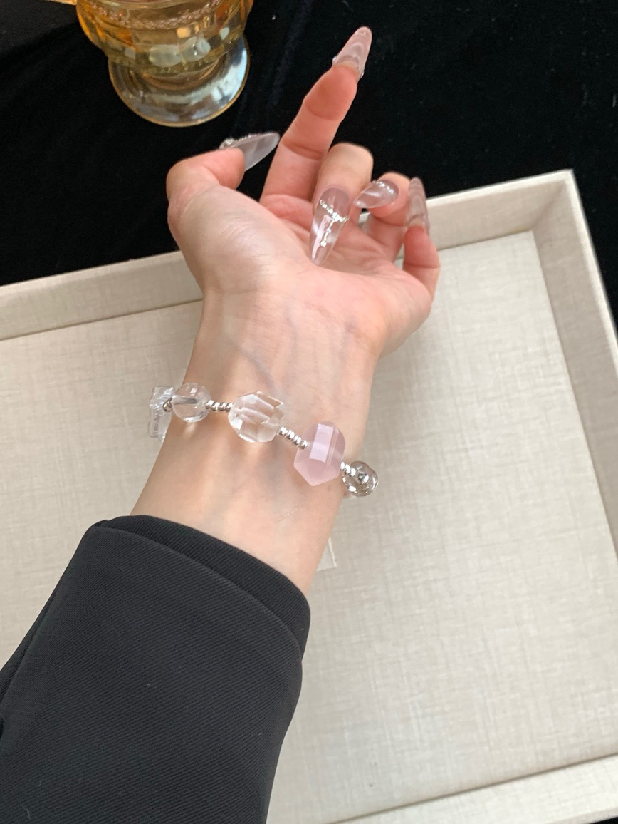 Hand shot showing the bracelet on wrist with subtle reflection.