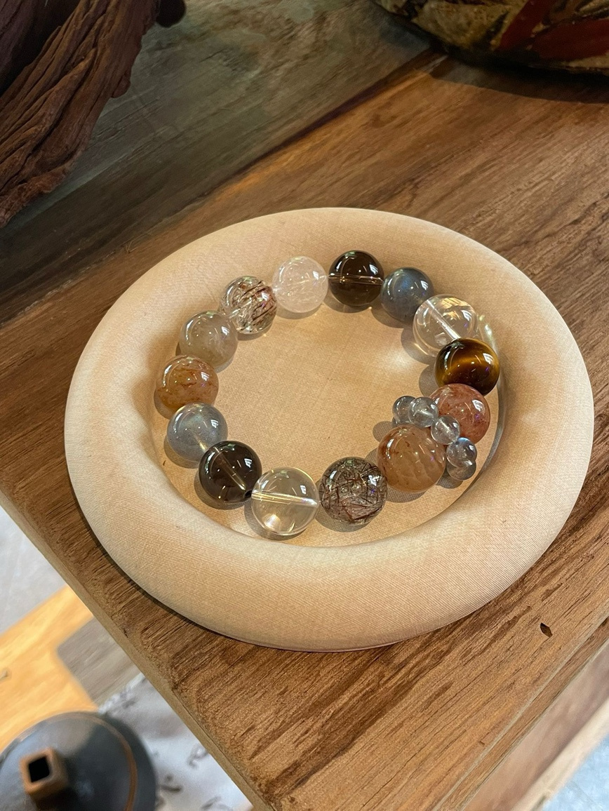 Natural Tiger’s Eye and Clear Quartz bracelet displayed on beige jewelry pad