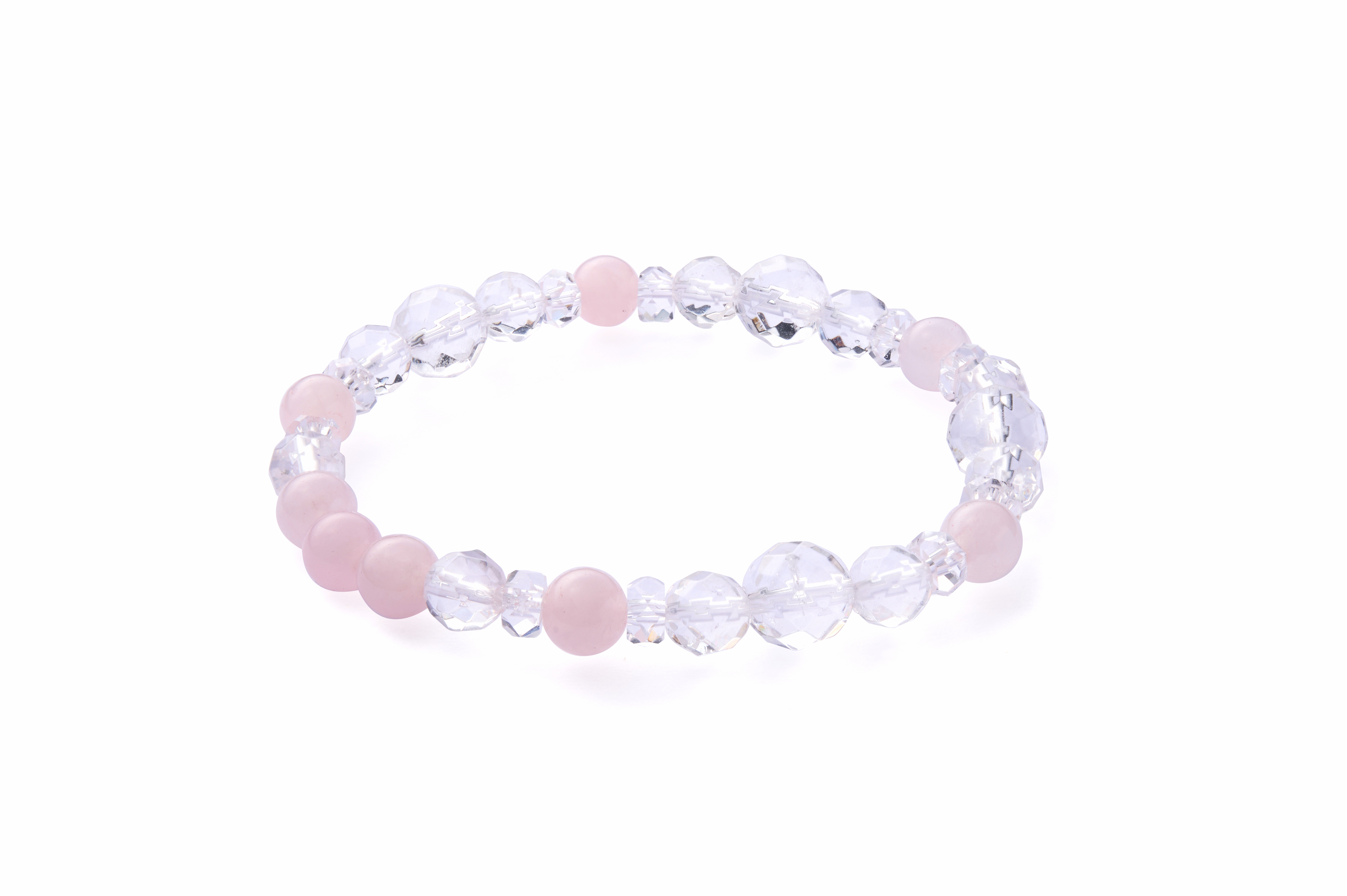 Top view on wooden tray highlighting crystal clarity and gentle pink tones, unisex bracelet
