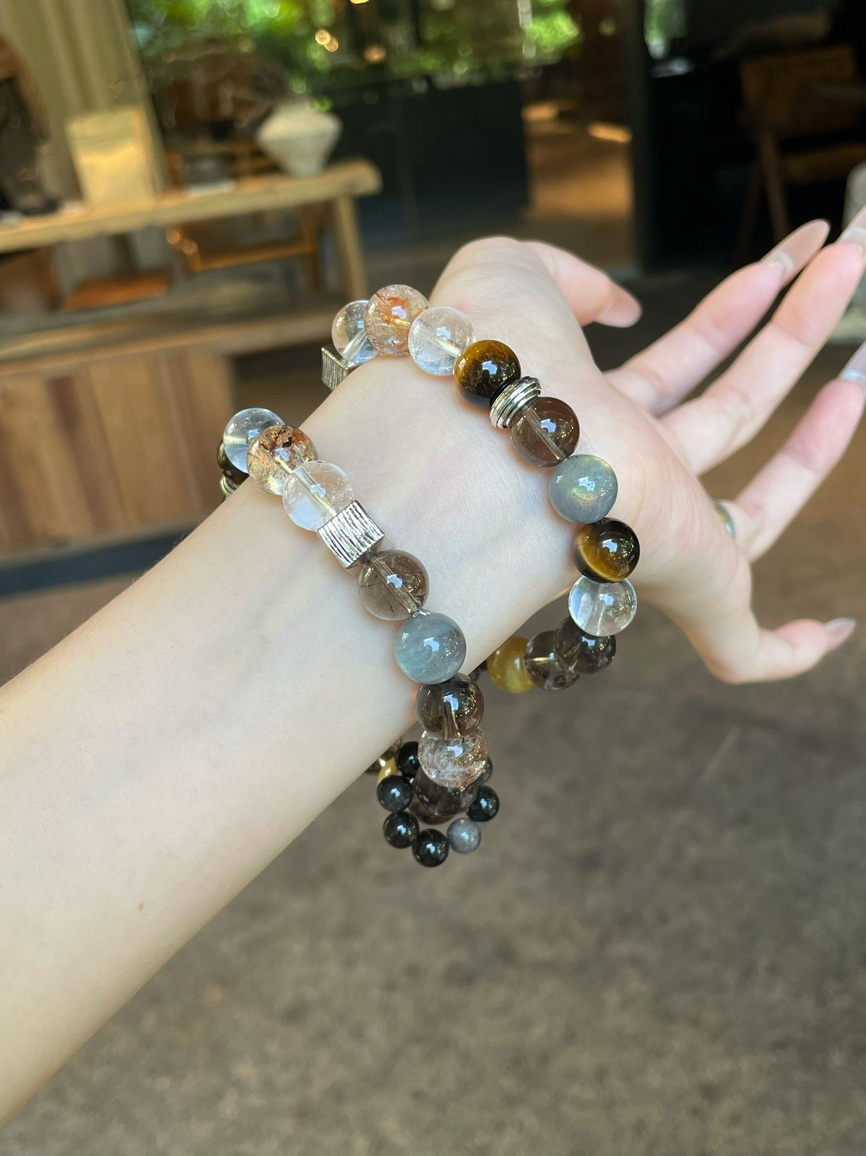 Double wrist look featuring layered energy bracelets.