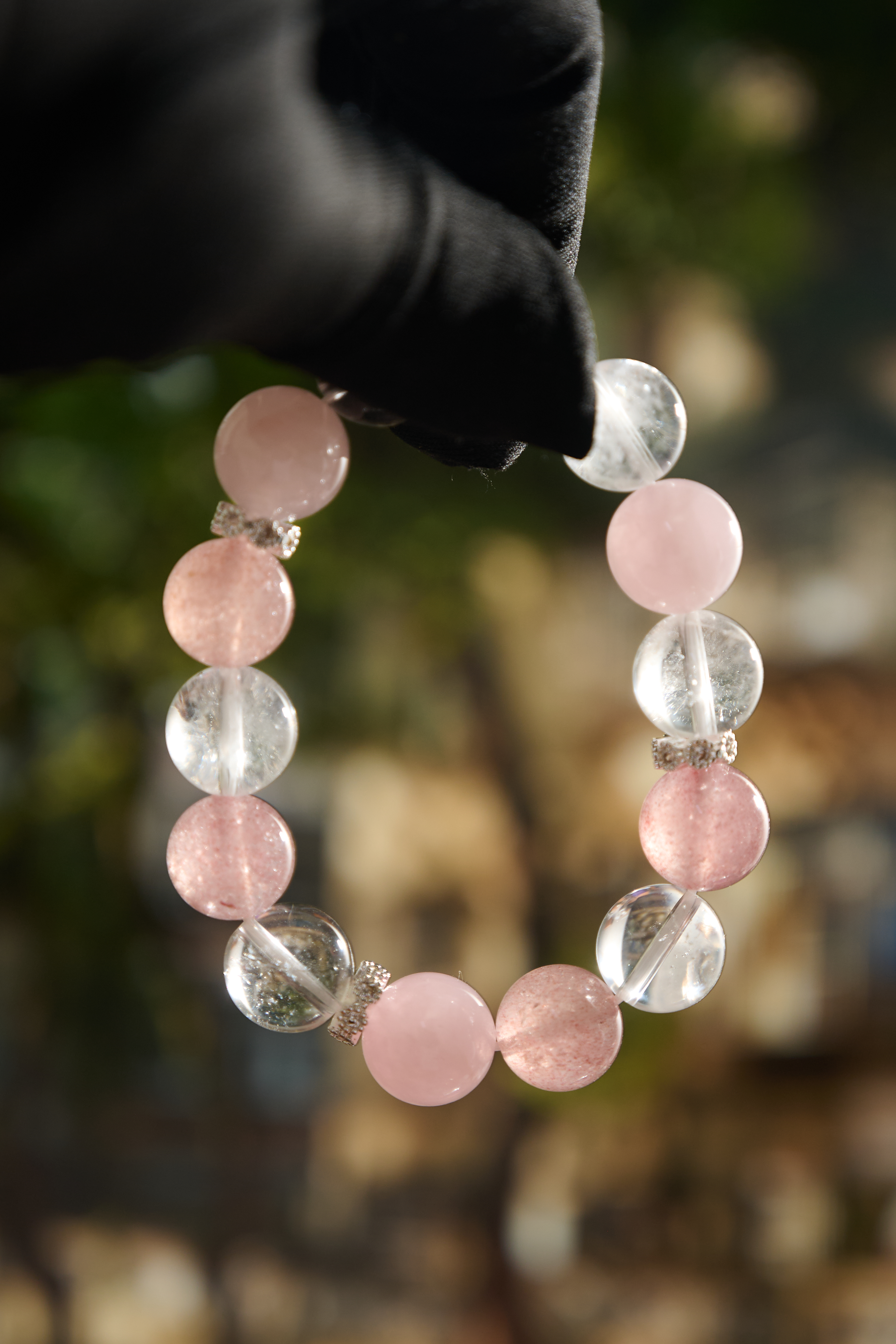 Wrist-on shot – rose & strawberry quartz crystal bracelet worn on hand, minimalist everyday style.