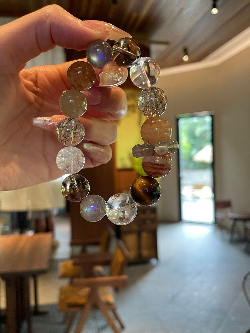 Hand holding energy crystal bracelet in natural light