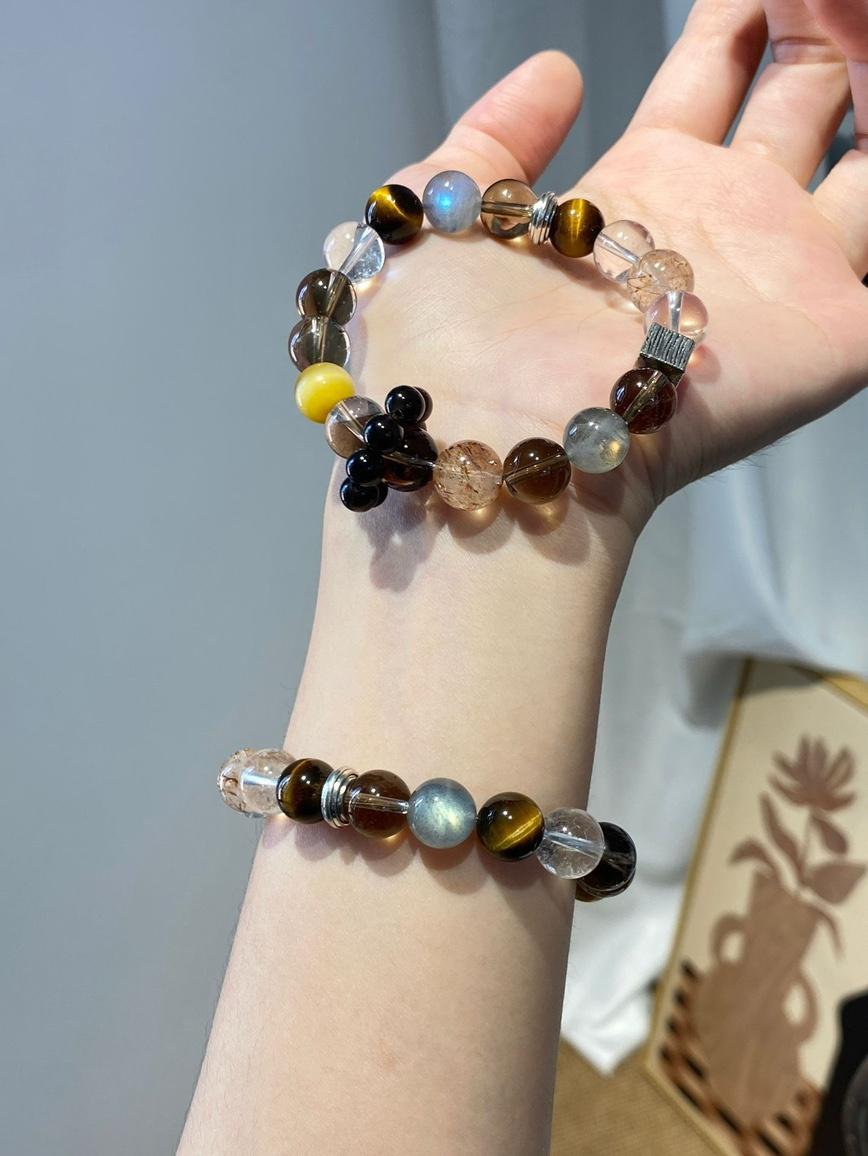 Bracelet displayed in a wooden jewelry box on fabric background.