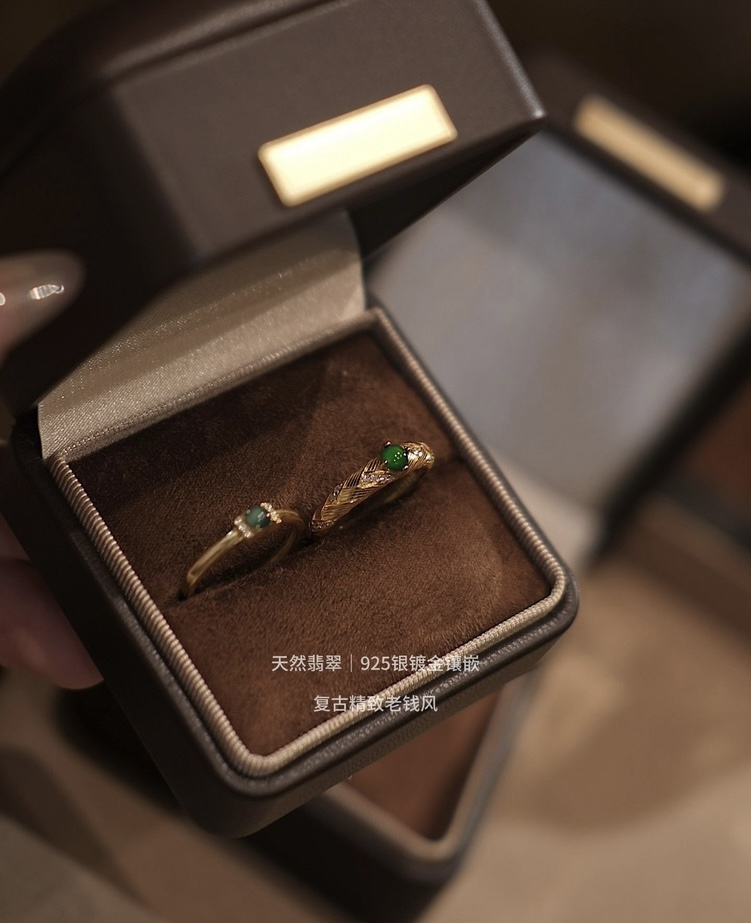 Pair of natural jade rings in velvet box with warm lighting