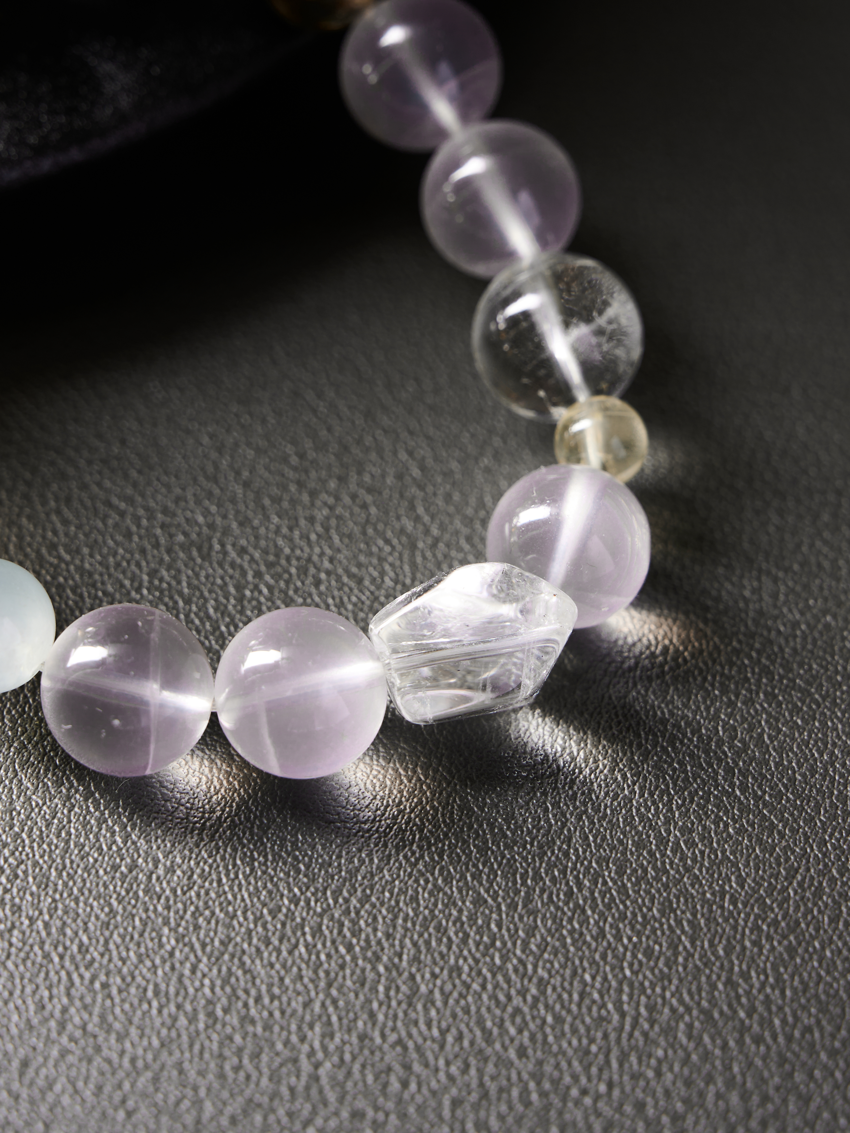 Extreme detail of center clear quartz accent and knot/cord finish, showcasing handcrafted quality
