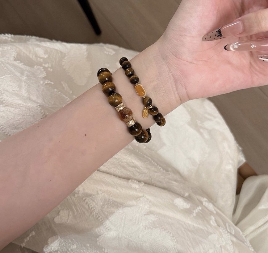 Close-up of Tiger’s Eye and Clear Quartz bracelet on wrist with neutral outfit