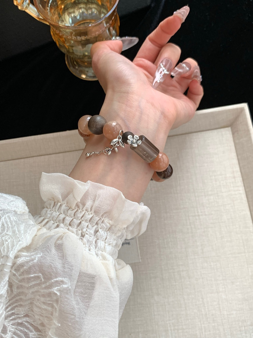 Moonstone and smoky quartz bracelet worn with elegant white blouse